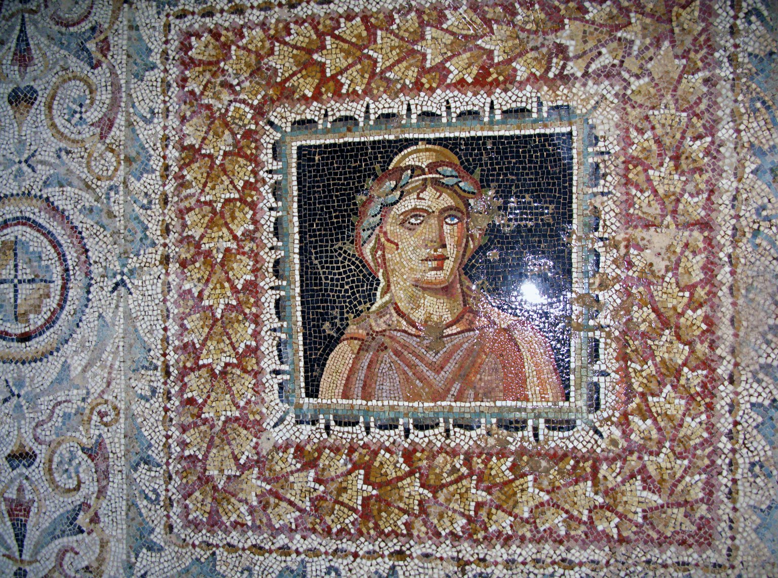 Ancient mosaic artwork featuring a woman's portrait