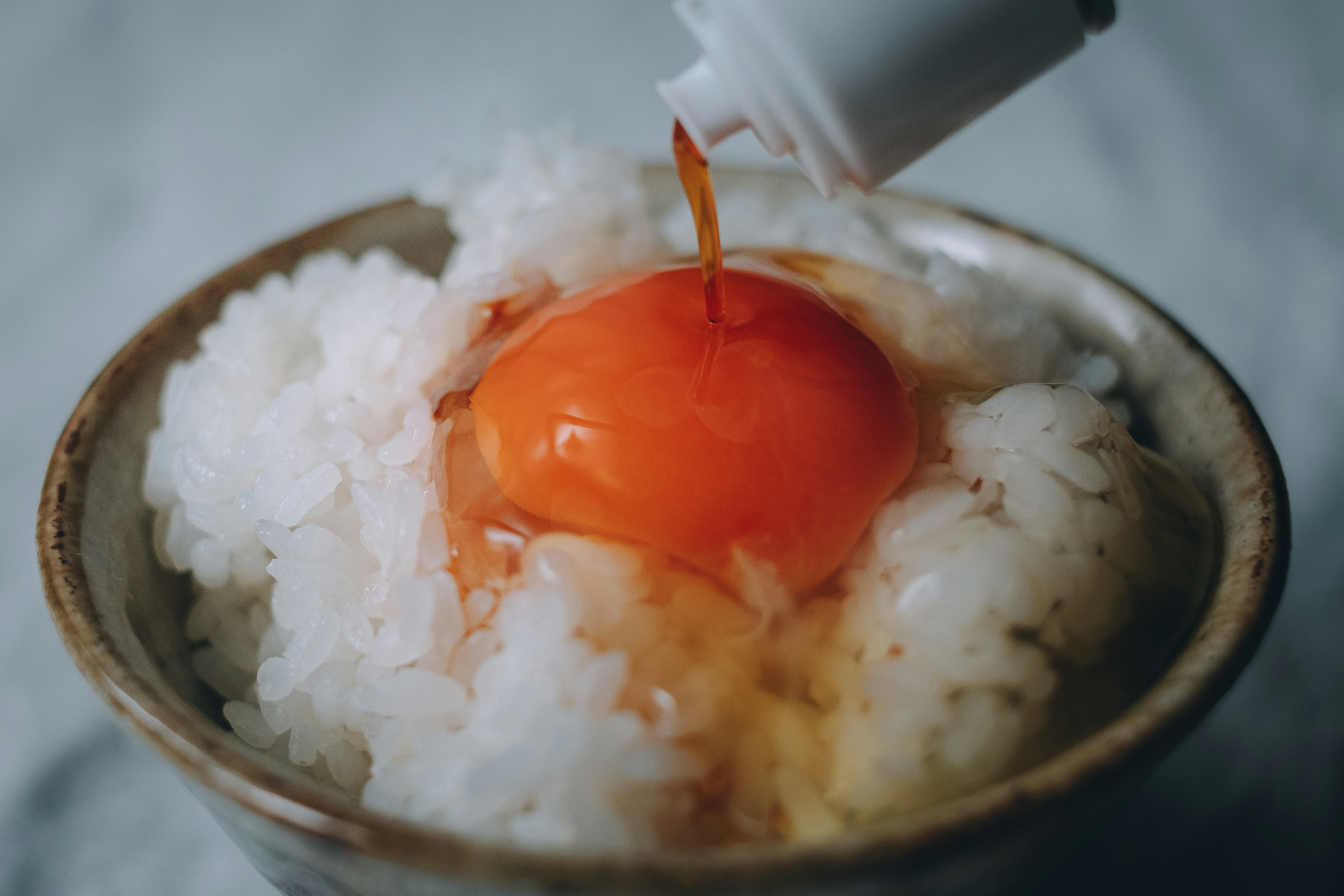 steaming rice bowl with a runny onsen egg