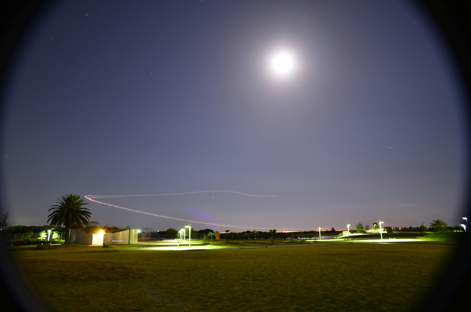 Night sky featuring a bright full moon and illuminated surroundings