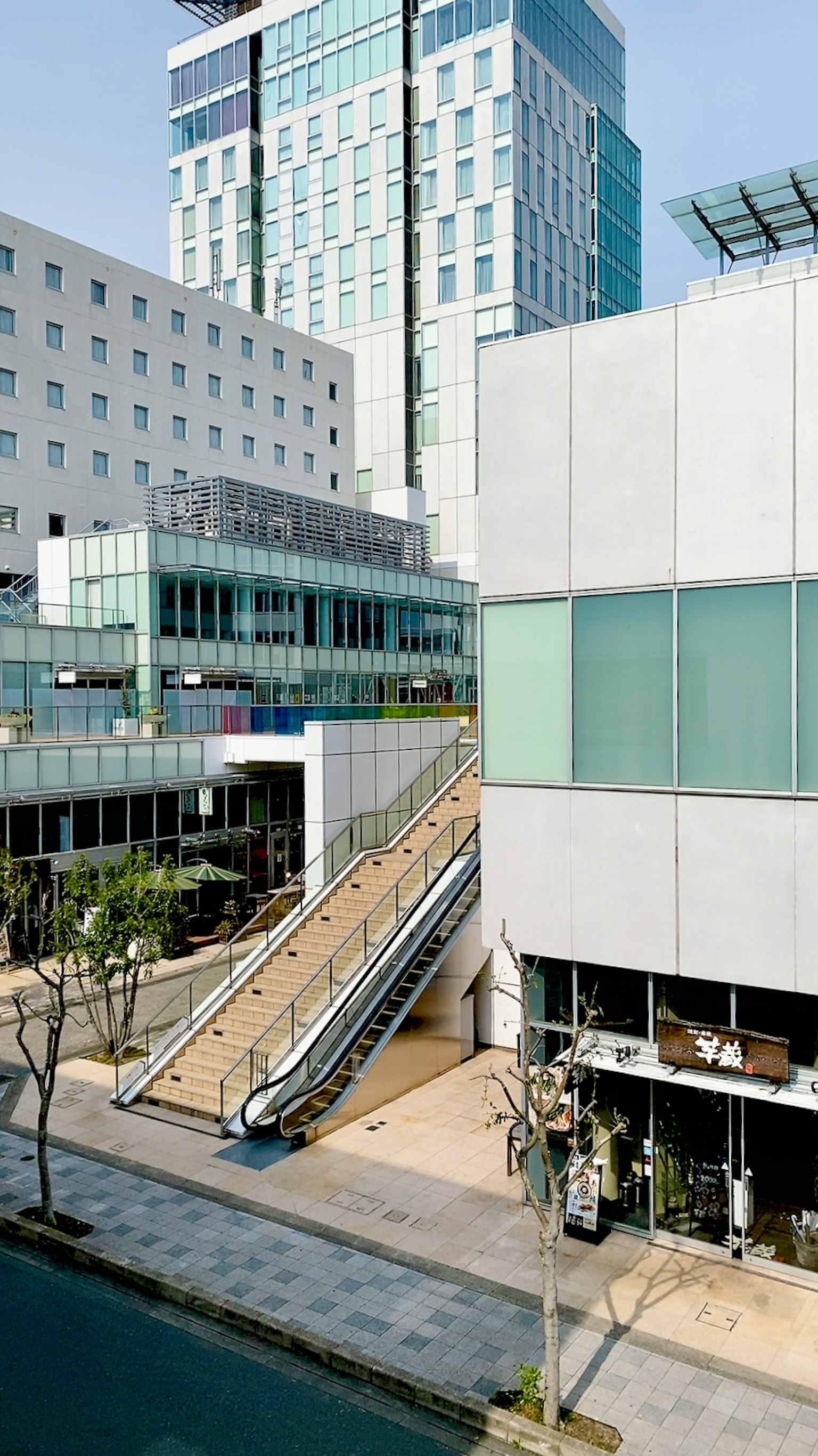 Urban landscape featuring modern buildings and an escalator