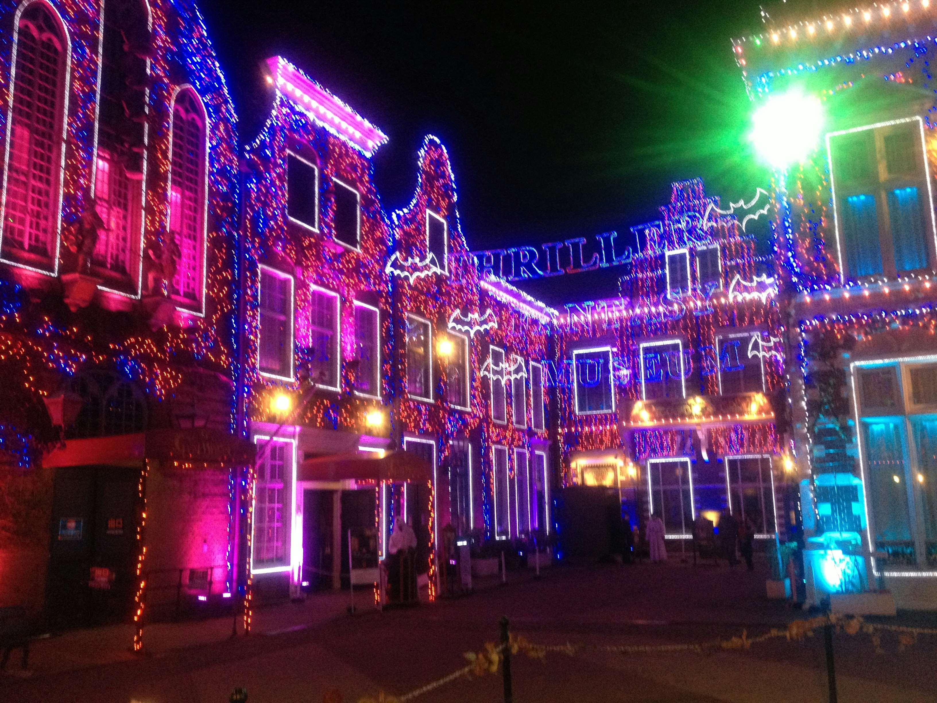 night street lined with colorful illuminated buildings image