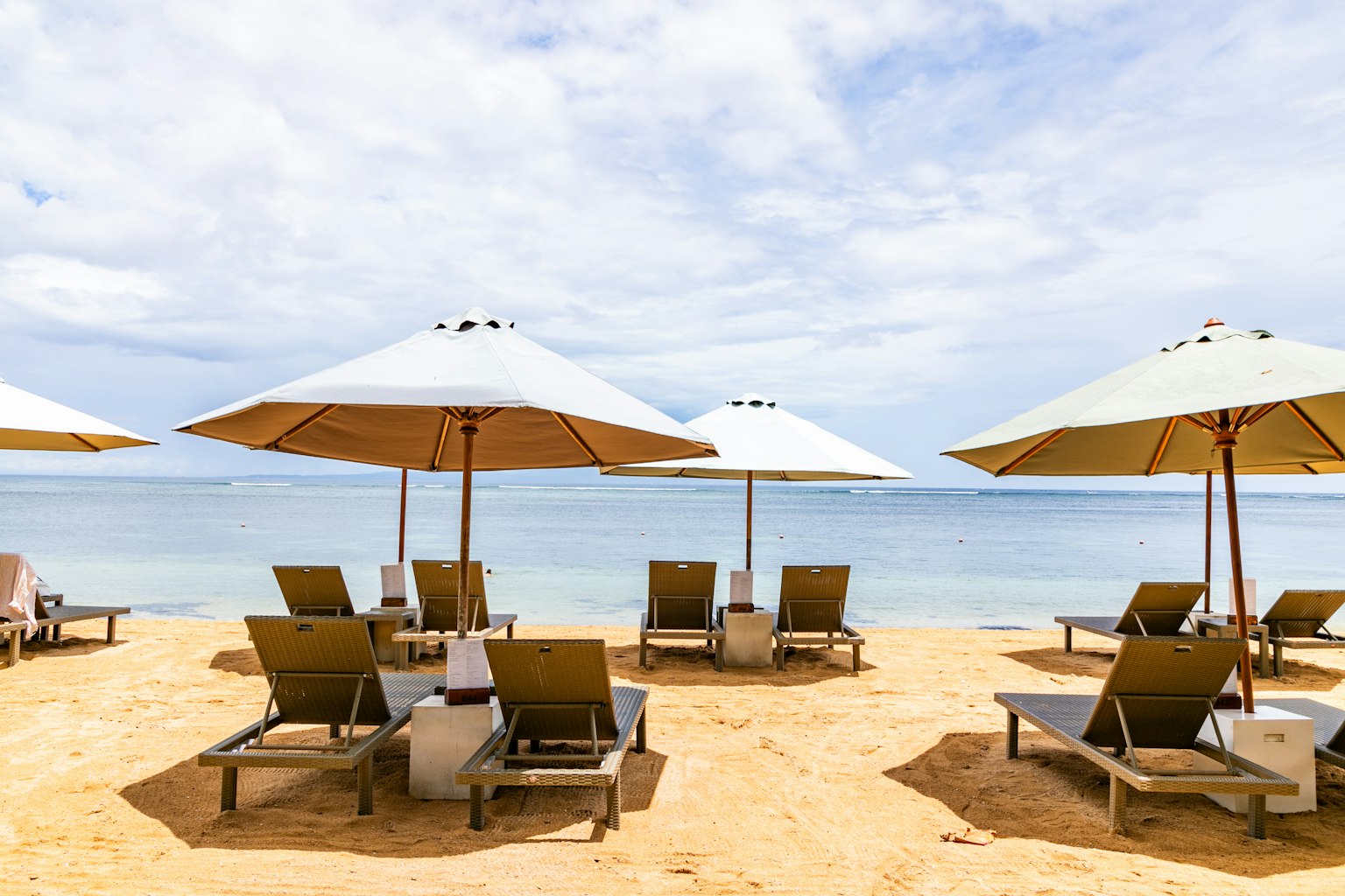 Beach scene with lounge chairs and umbrellas