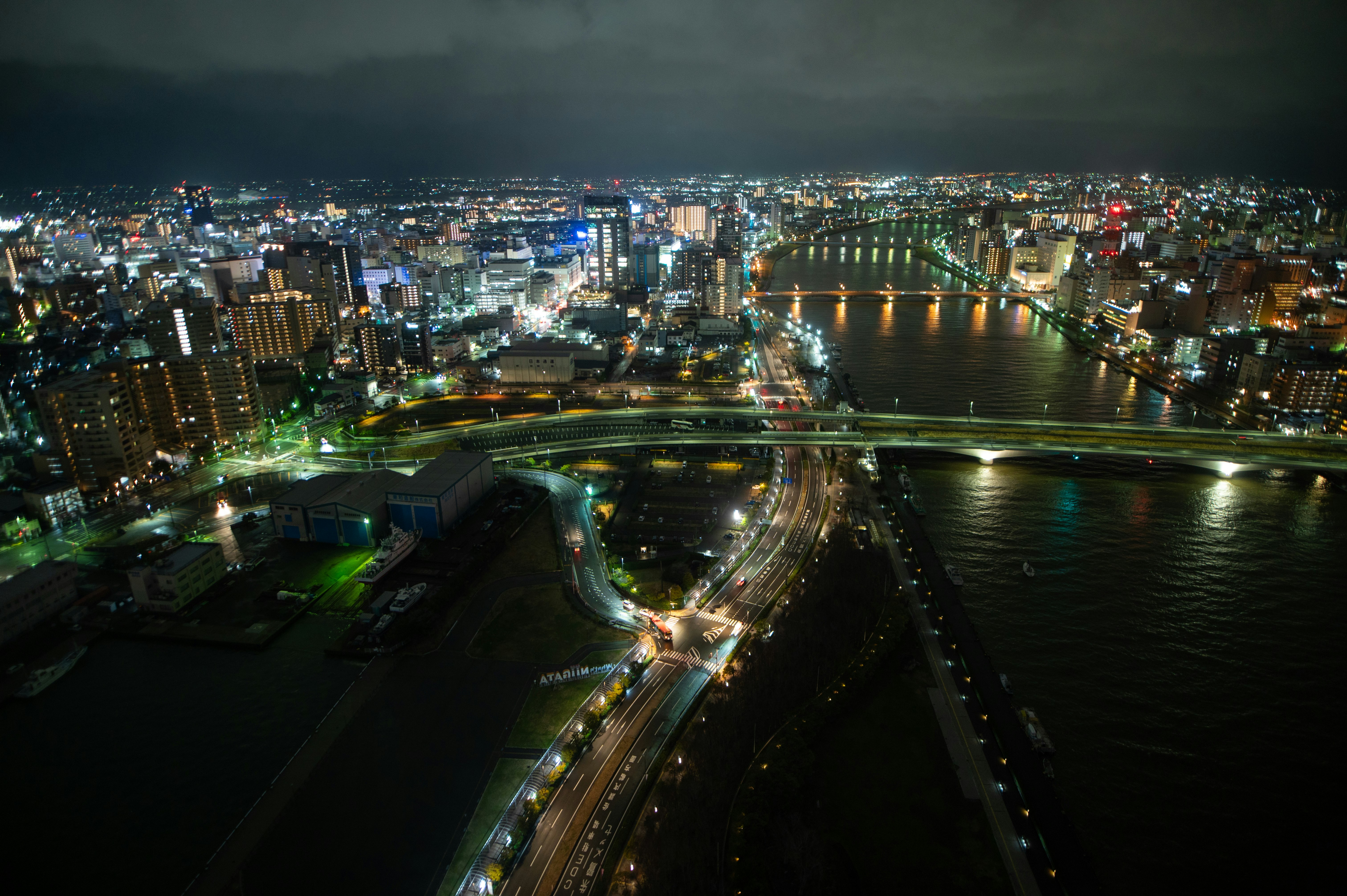 夜景の川沿いを走る高速道路と街の灯り