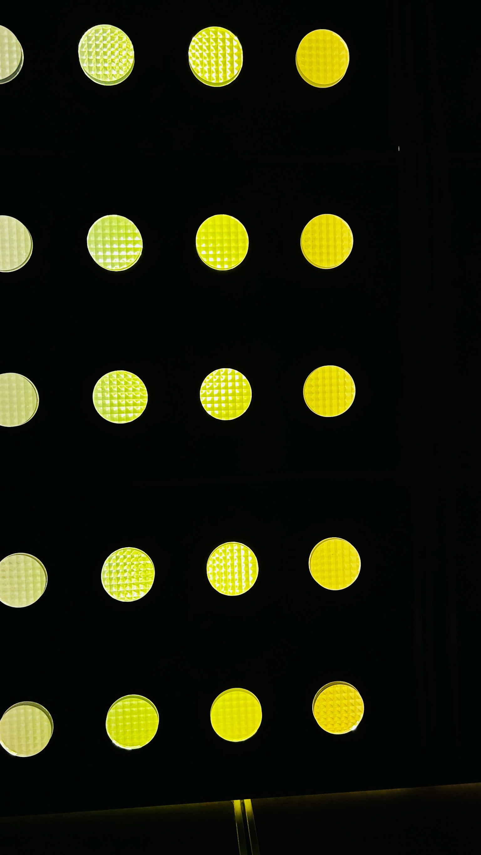 Pattern of yellow and white dots arranged on a black background