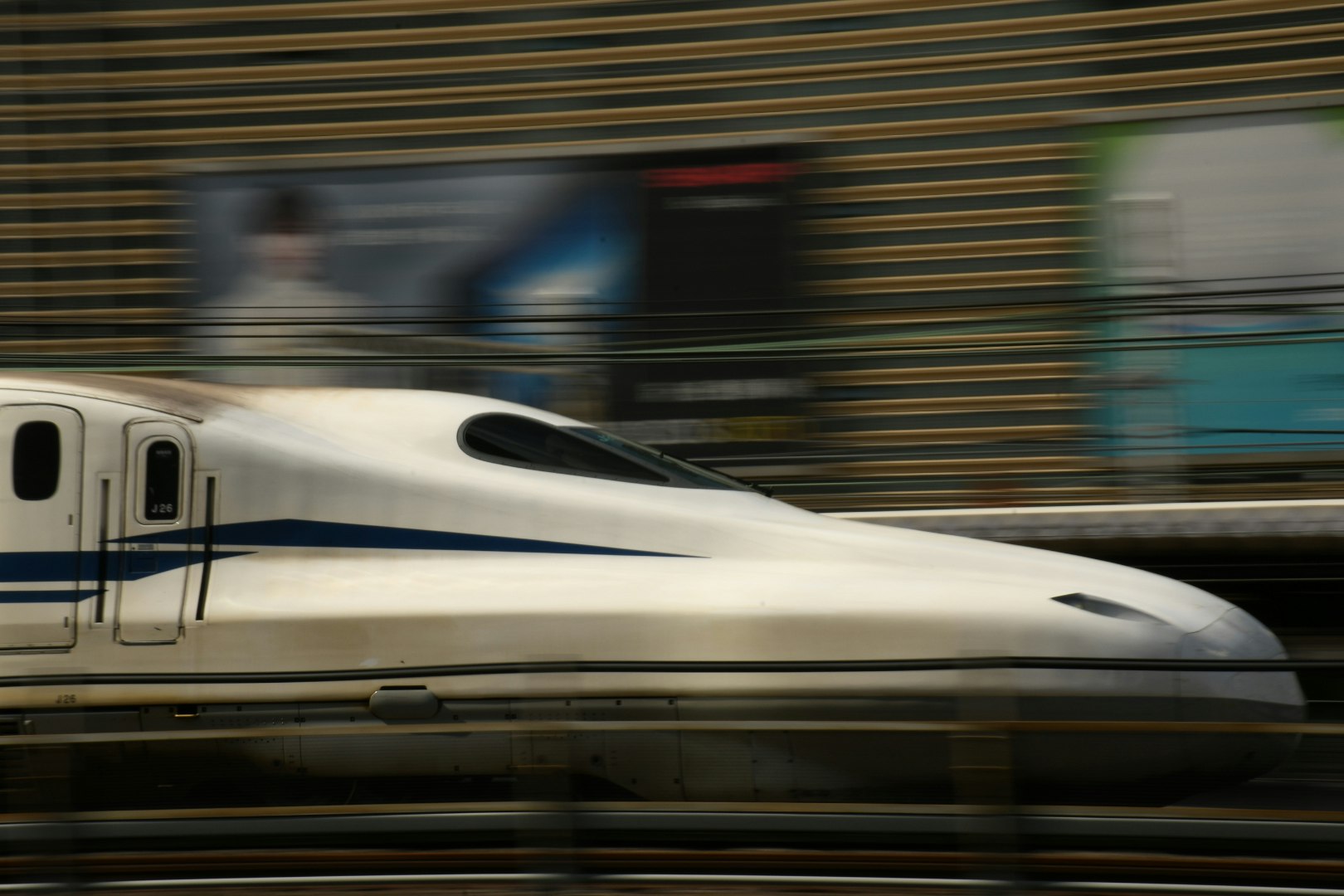 A high-speed train passing on elevated tracks