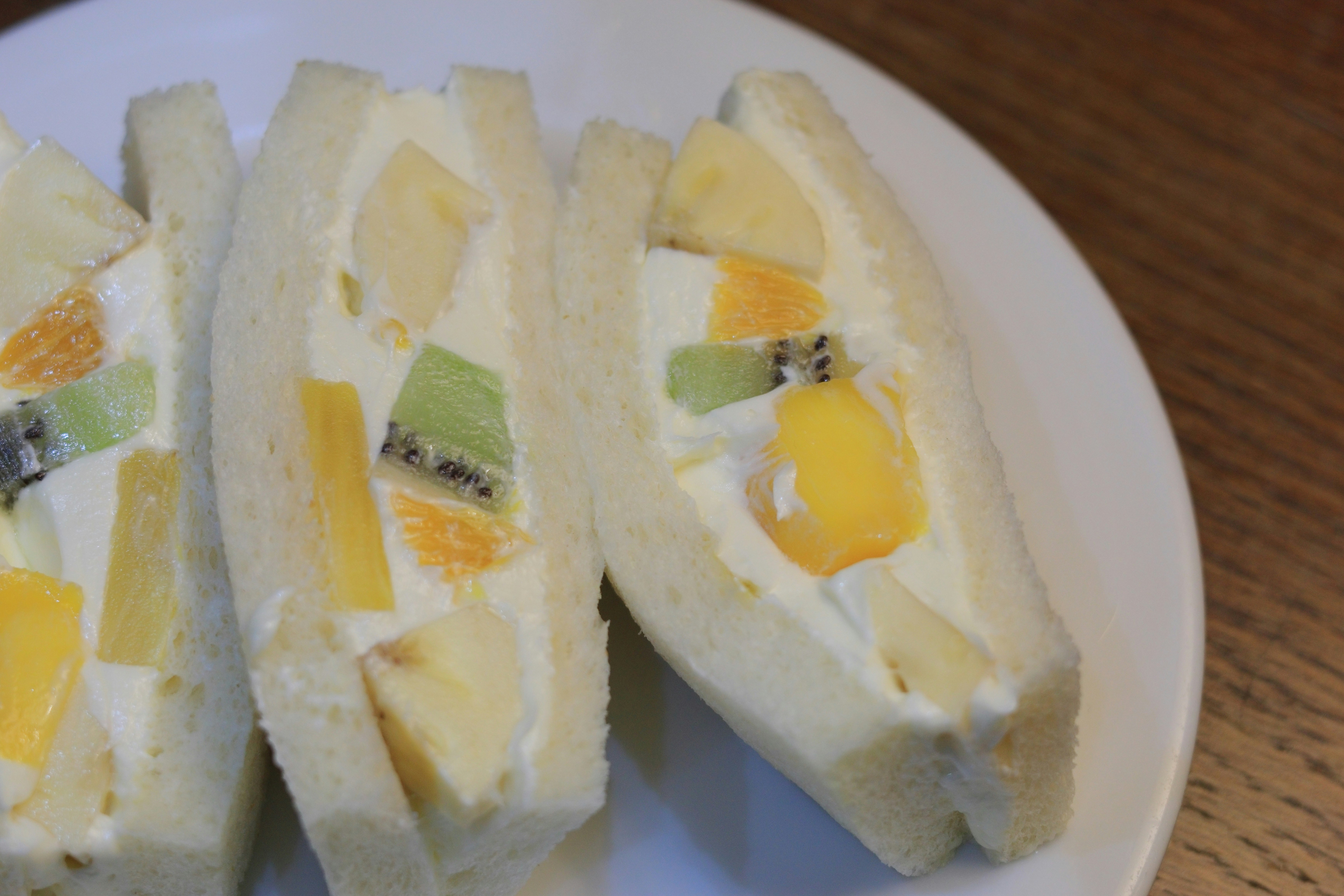 close-up of sliced egg sandwiches on a plate