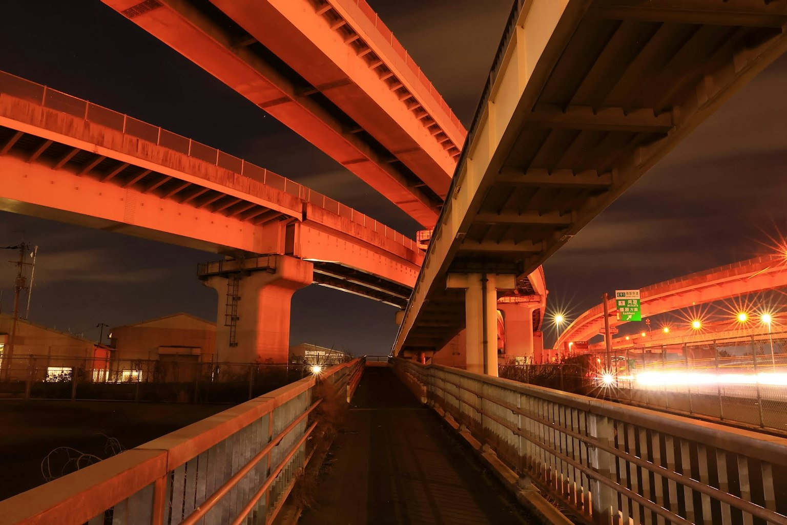 Intersecting elevated highways at night with vibrant lighting