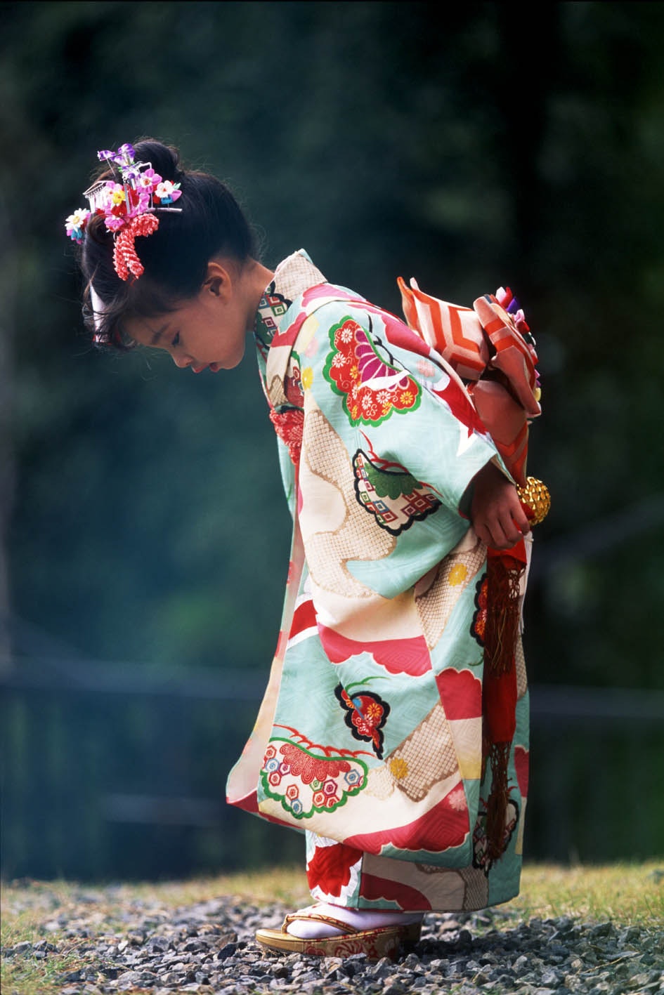 vista trasera de un niño con kimono de pie sobre el pasto