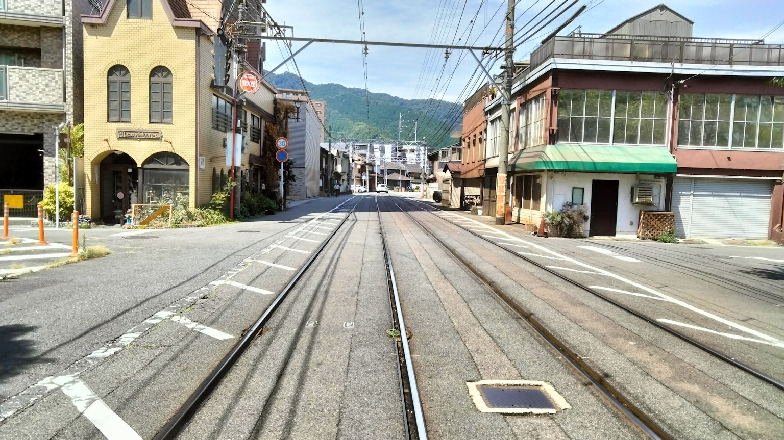 Quiet street scene with intersecting tram tracks