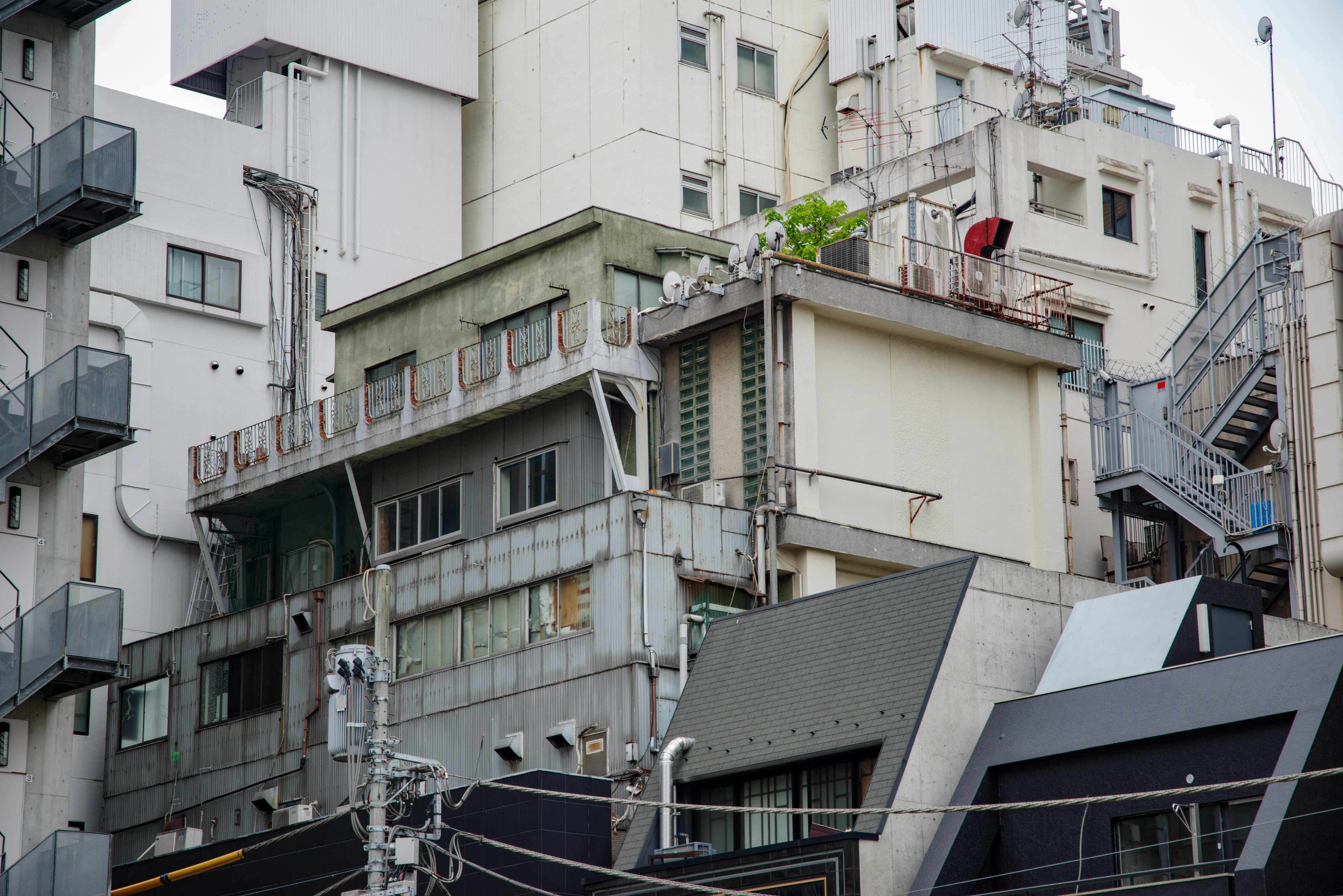 路地裏の古い集合住宅と配管のある建物群