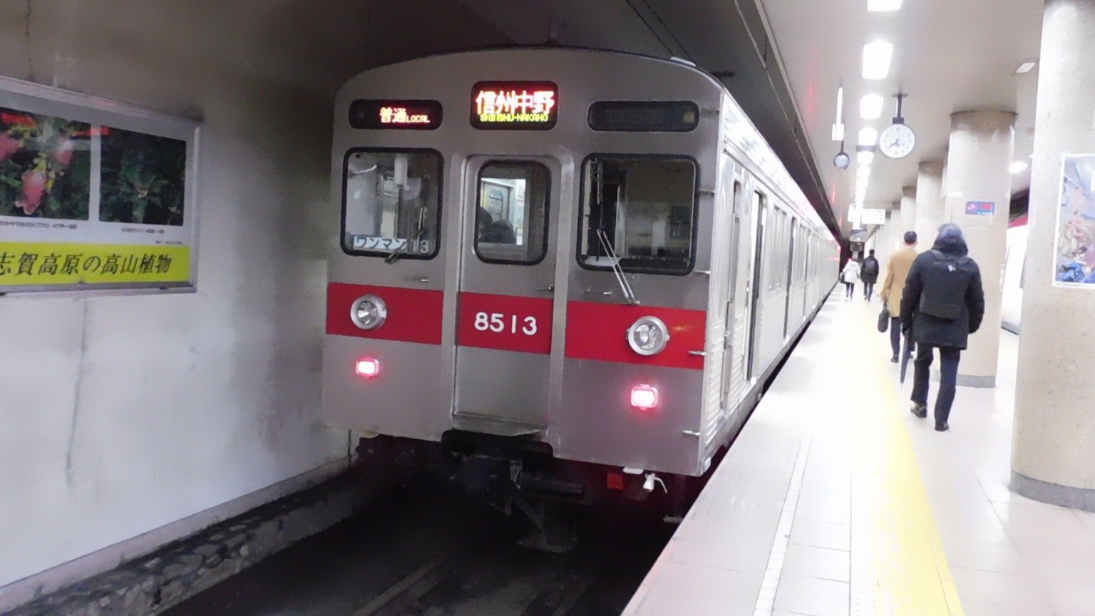 Sebuah kereta merah dan perak tiba di stasiun