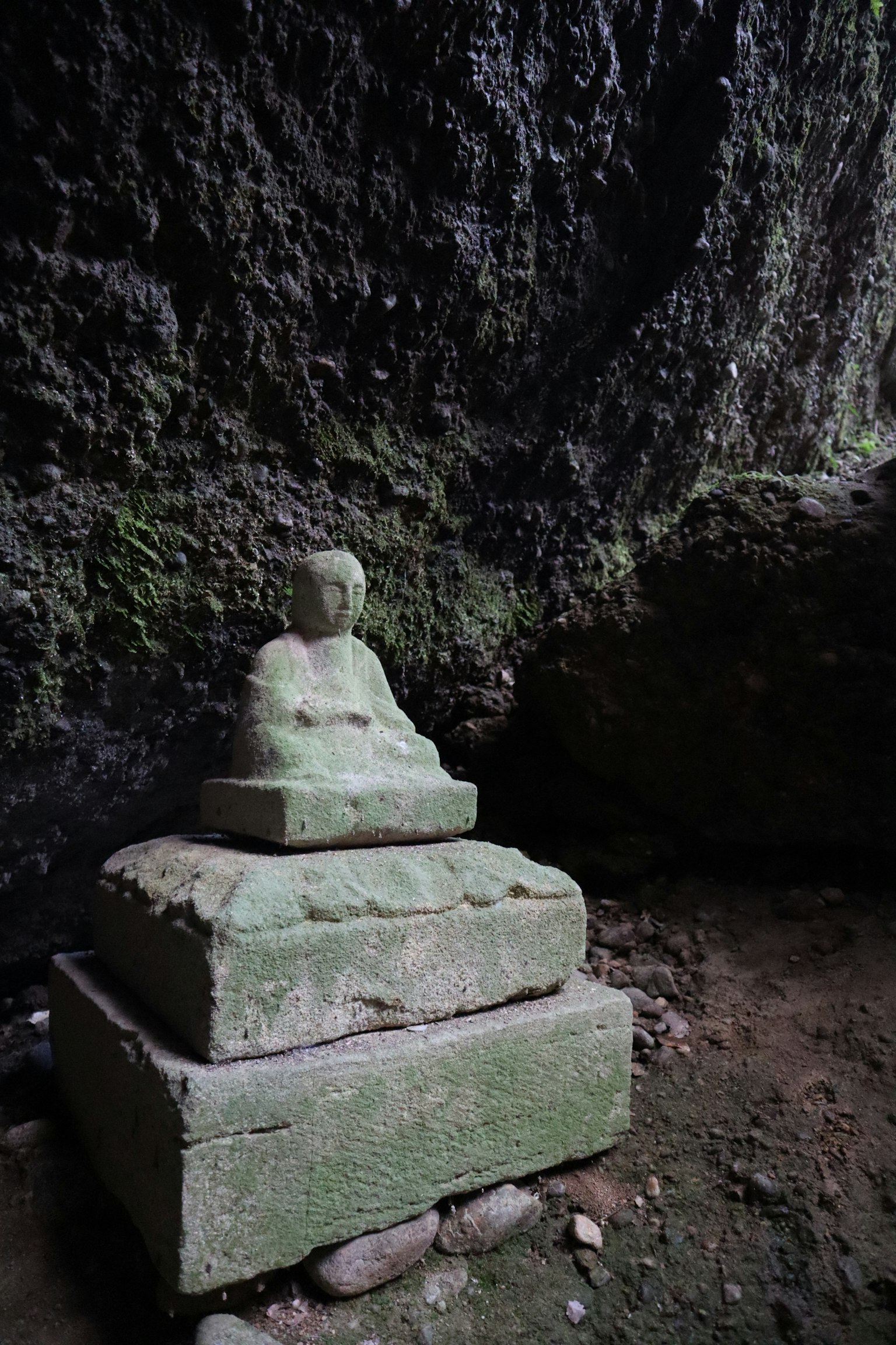 Stone Buddha statue inside a cave