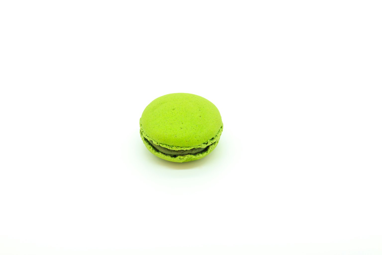 Green macaron placed on a white background