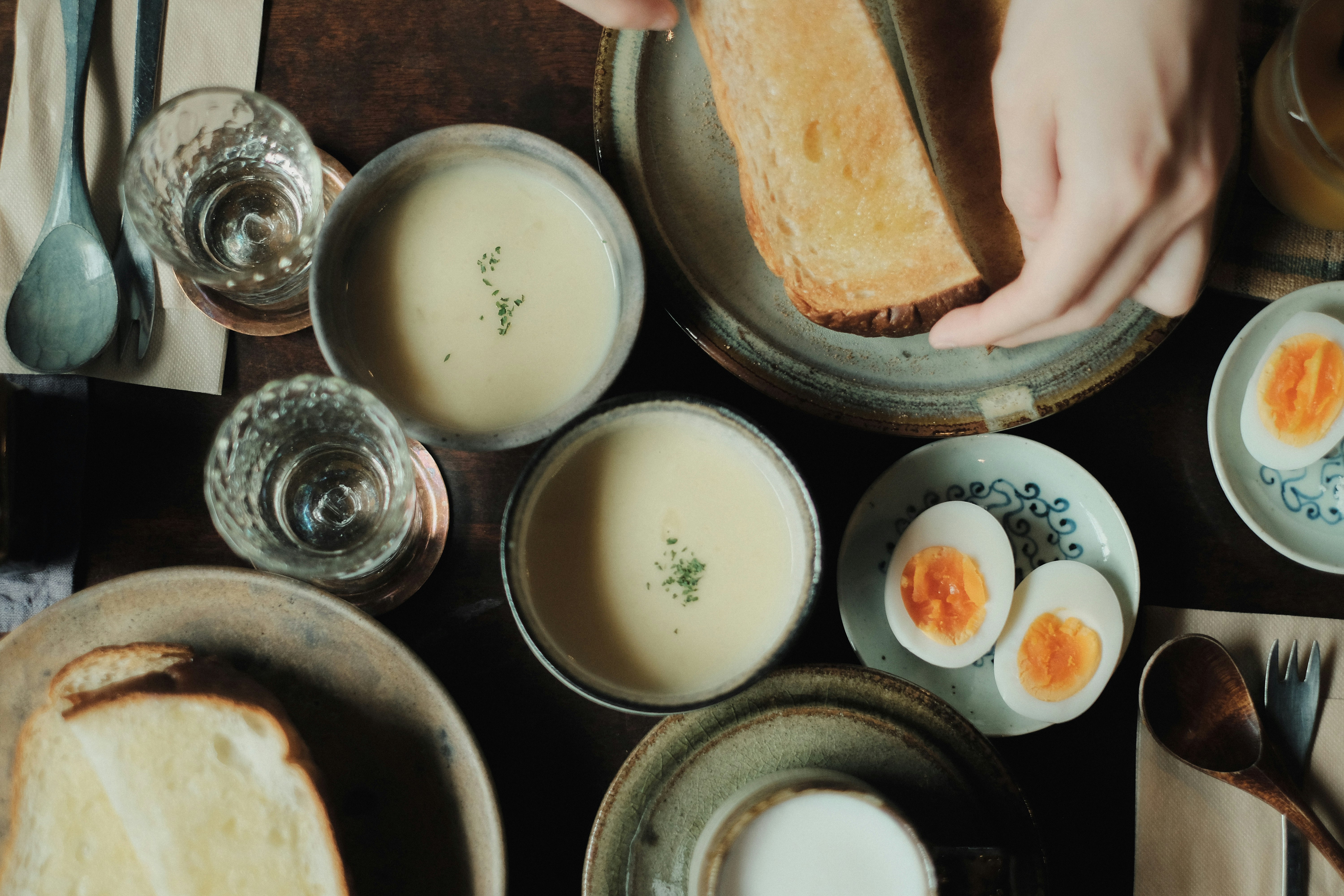 Japanese meal table with bowls of soup and bread