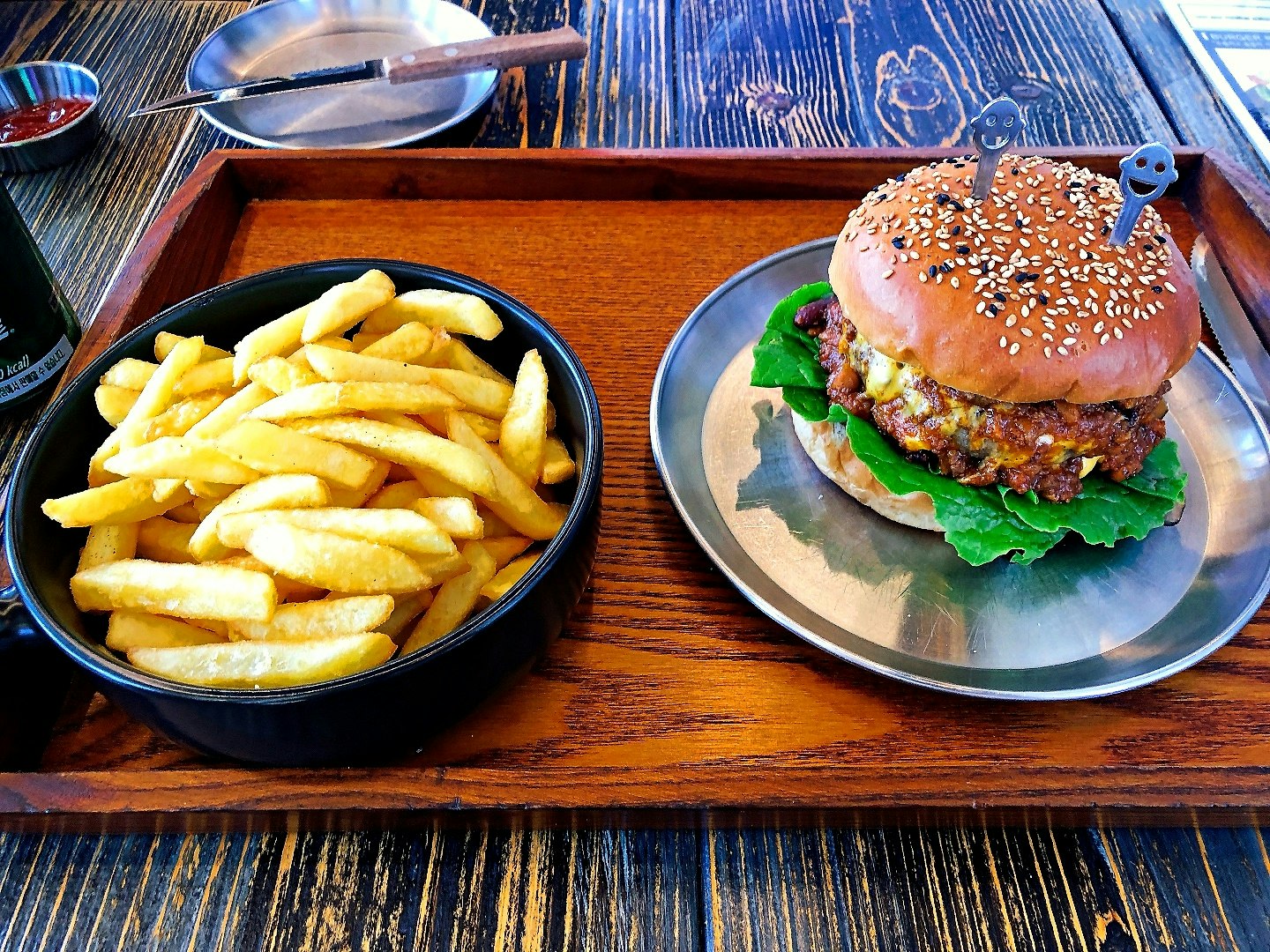burger and fries on a wooden tray