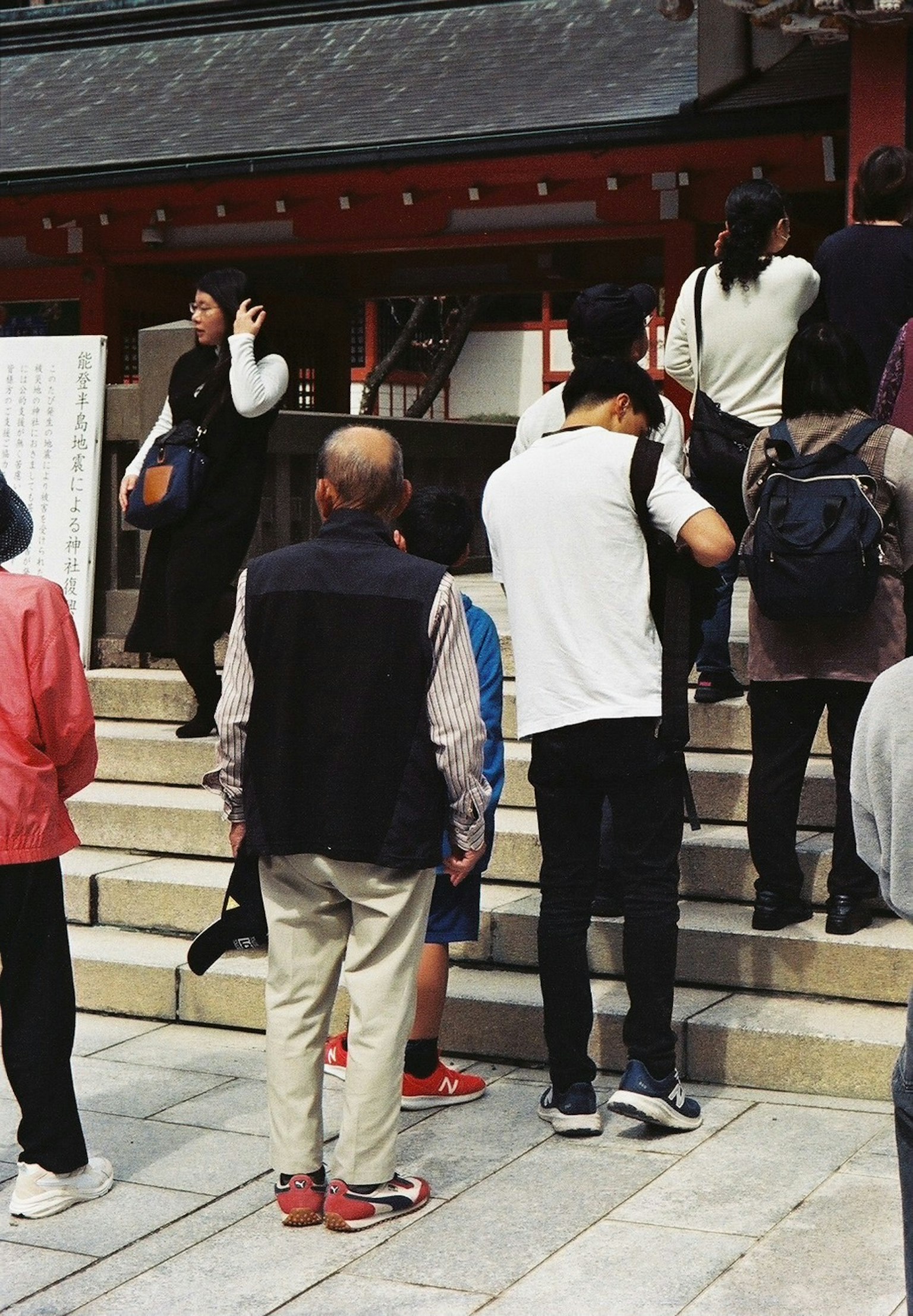 A scene of people ascending the steps of a shrine