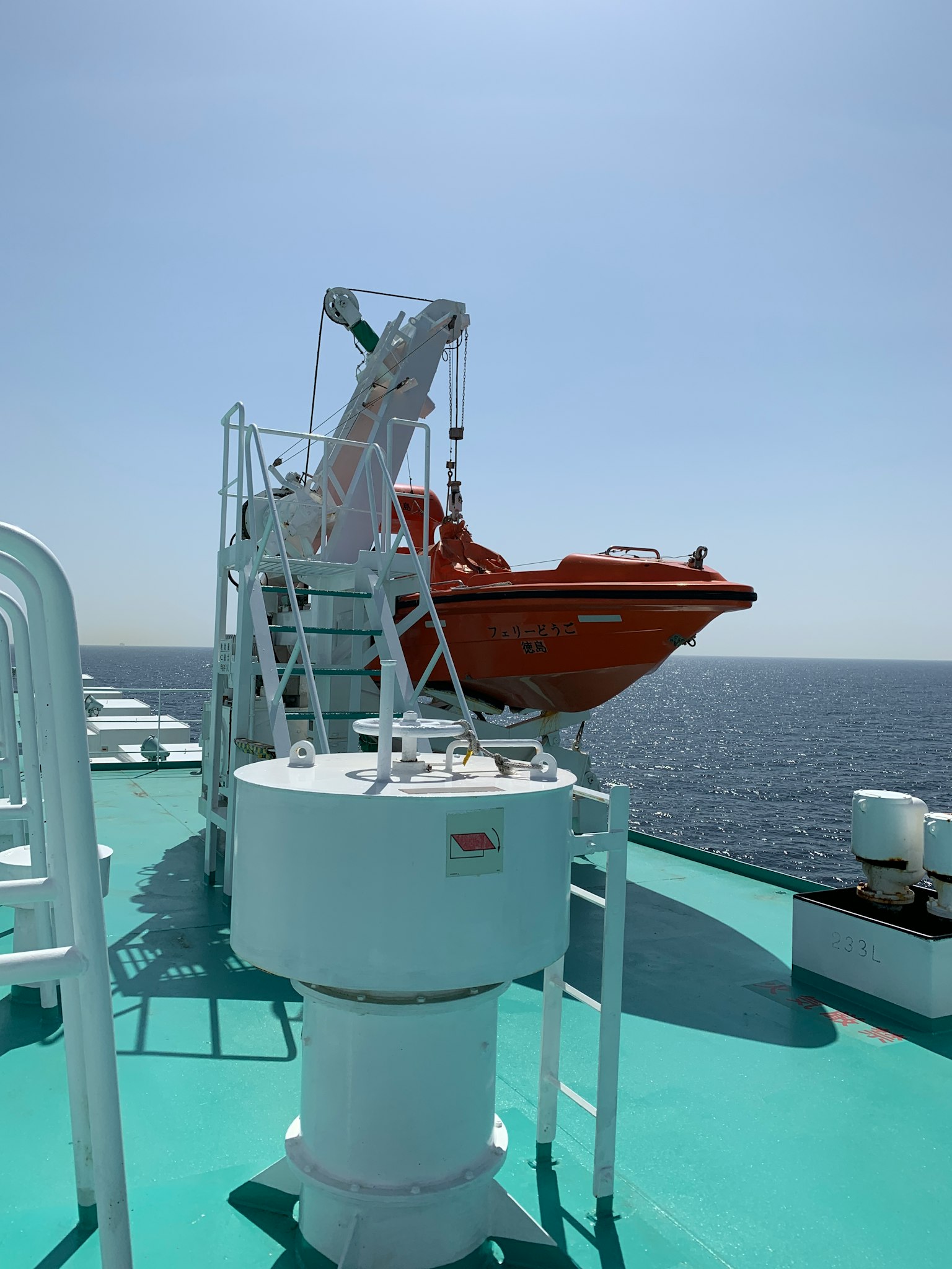 Lifeboat and its mechanism on a ship deck overlooking the sea