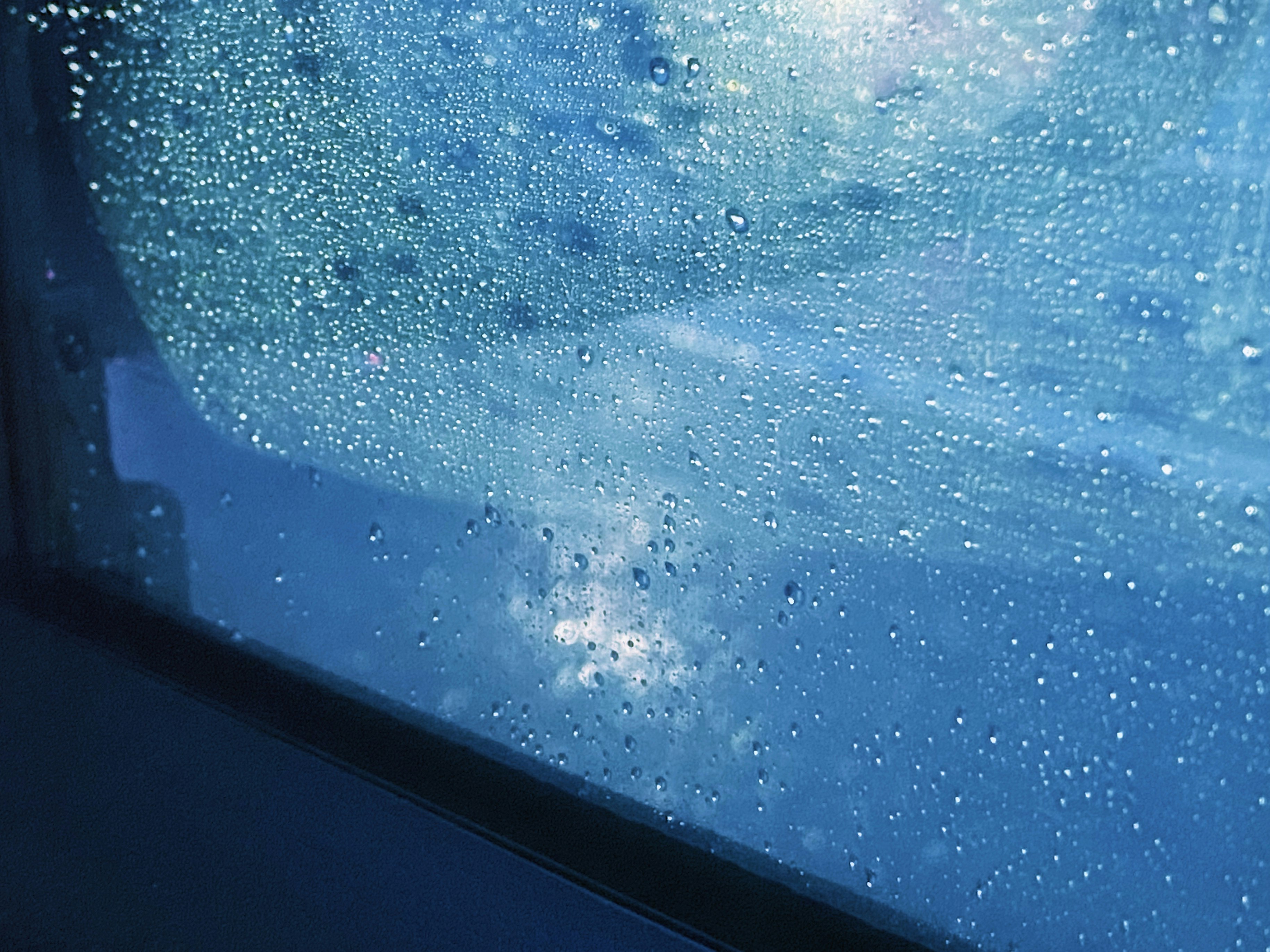 underwater view through a window with bubbles and light particles