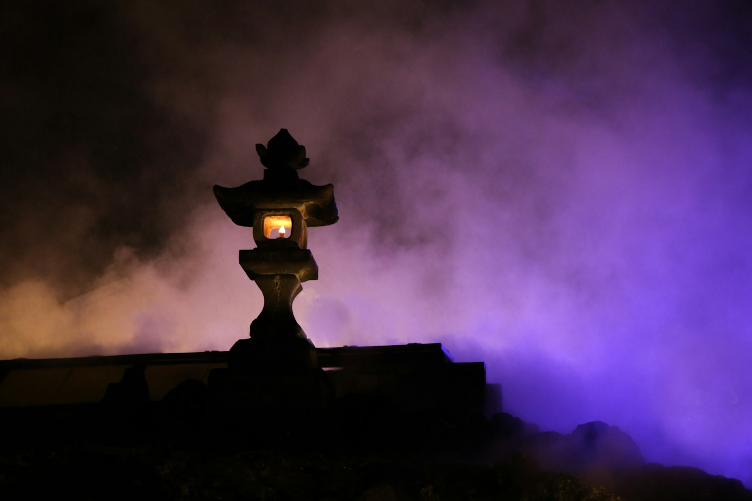 Lantern silhouette against a purple fog