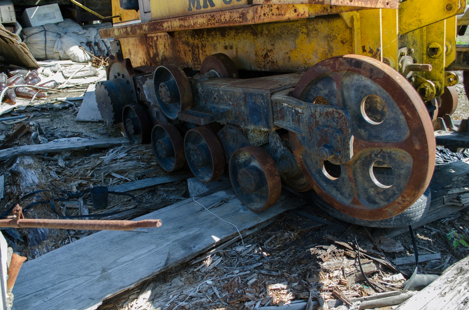 Old machinery tracks in a wreckage with debris scattered around