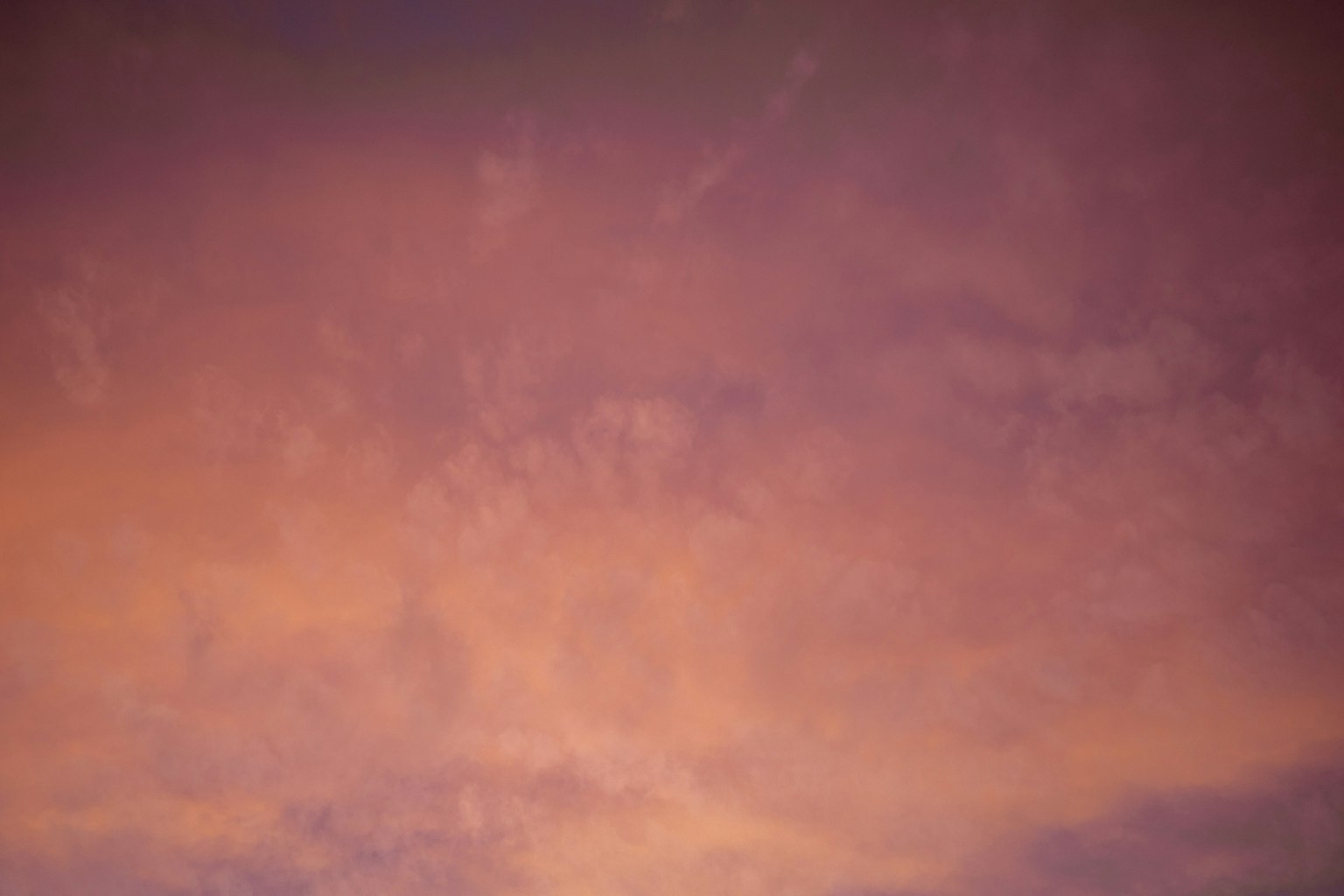 Purple and orange clouds spread across the sunset sky