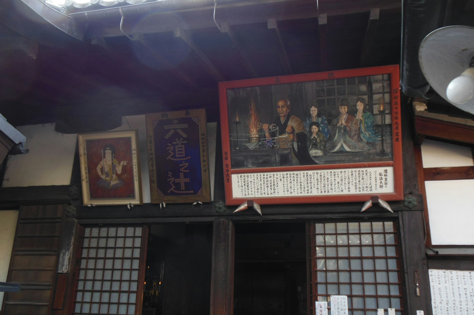 传统日本建筑外观，挂有色彩斑斓的画作和装饰性标志