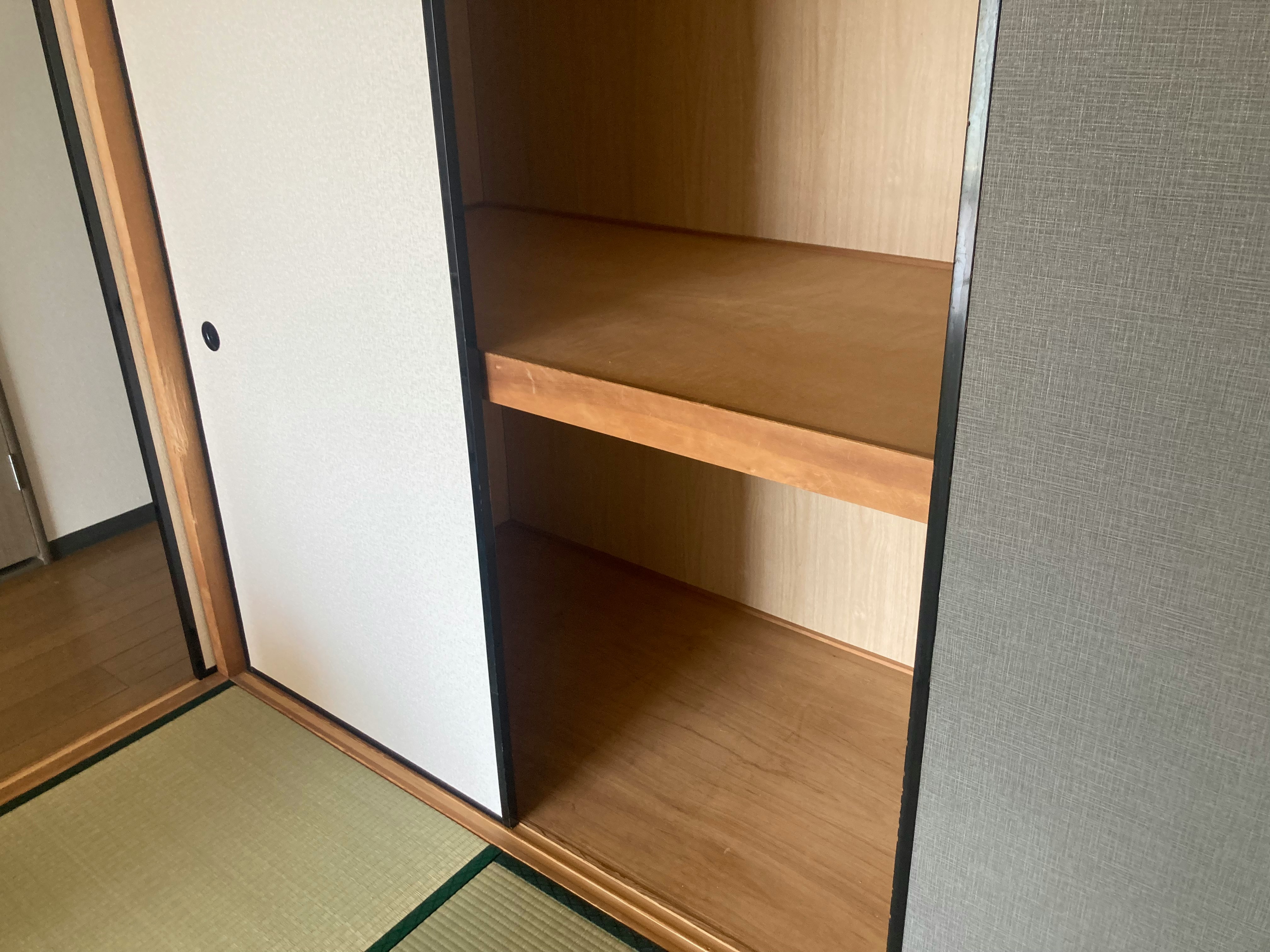 Indoor room with tatami mat and wooden shelving