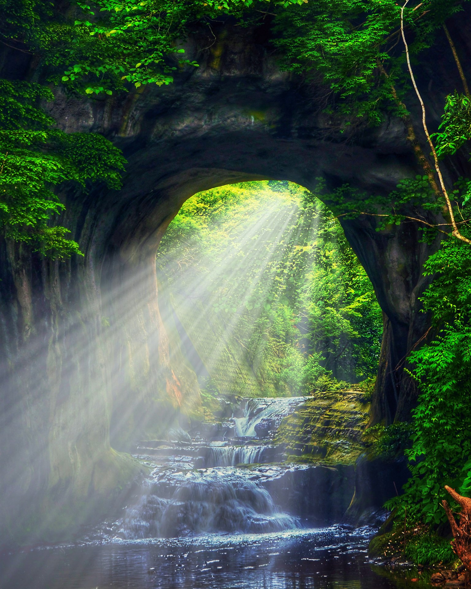 Grüner Tunnel mit Lichtstrahlen und Wasserfall