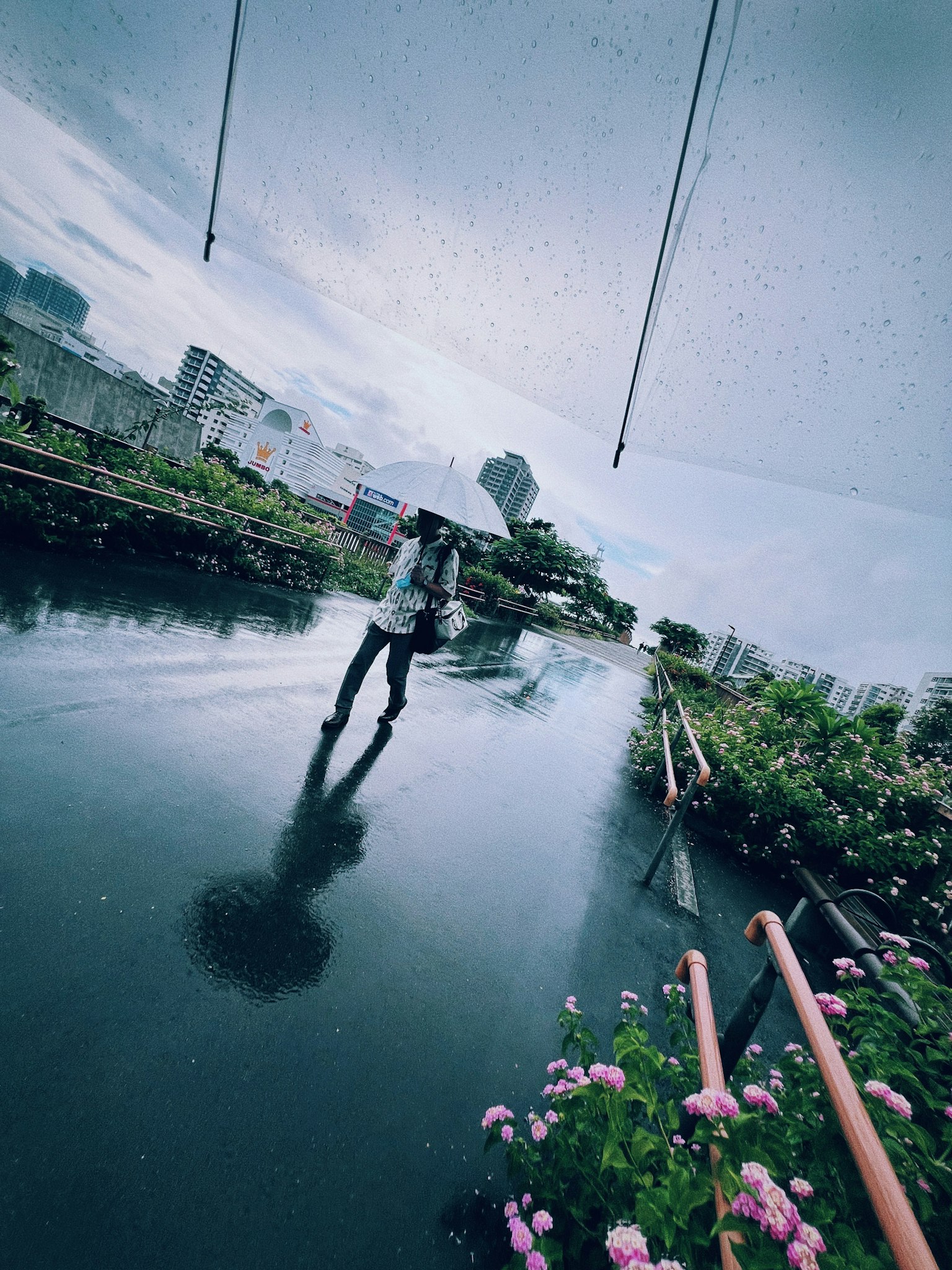 Une personne tenant un parapluie marchant sur une surface d'eau réfléchissante