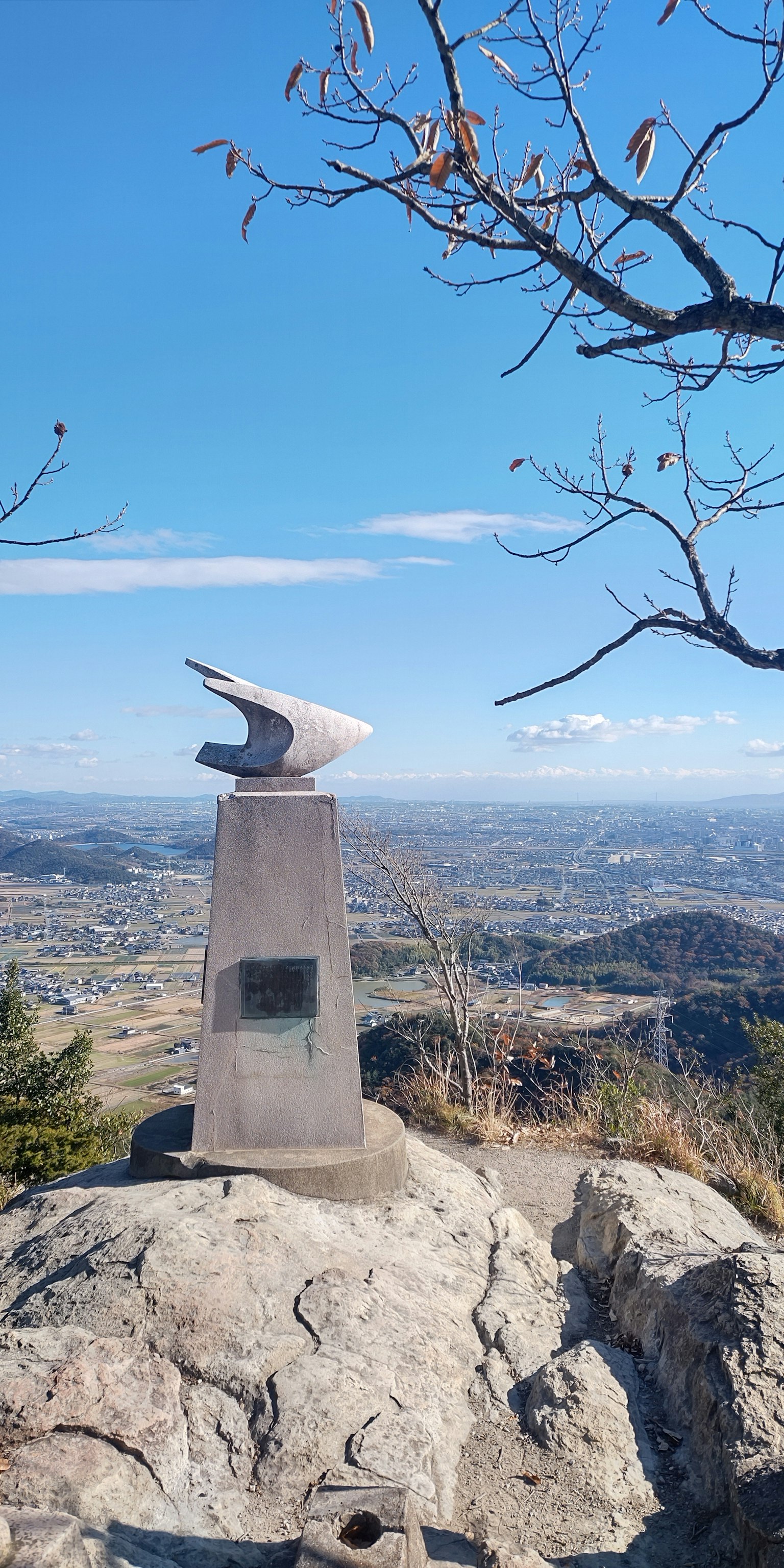 Sculptural monument at the mountain peak with expansive landscape