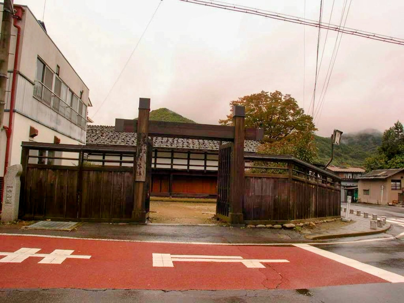 Traditional Japanese building with wooden fence on a quiet street