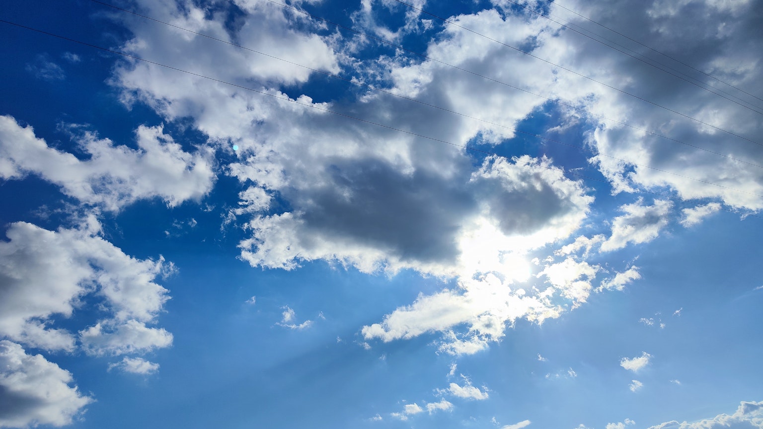 Bright scene with white clouds in a blue sky