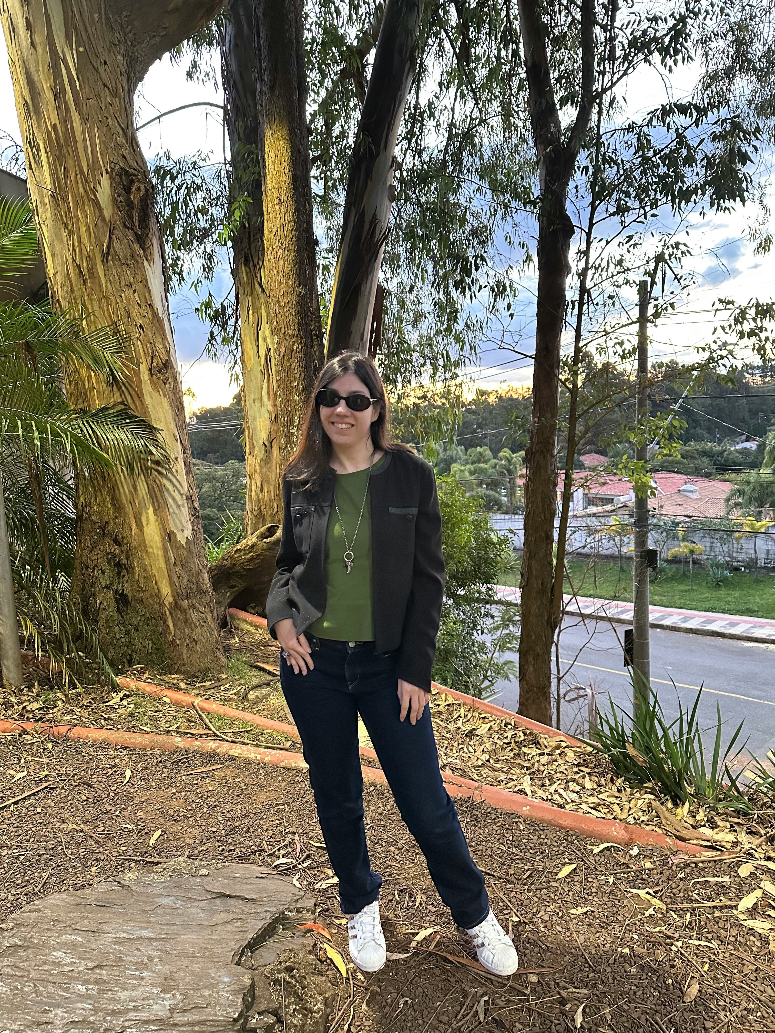 person posing outdoors among trees