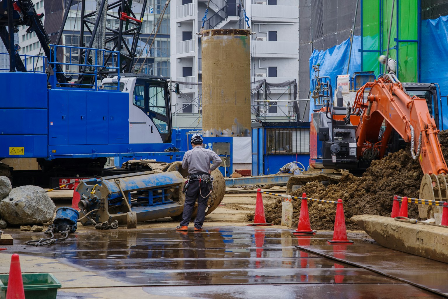 Construction site with a worker and heavy machinery
