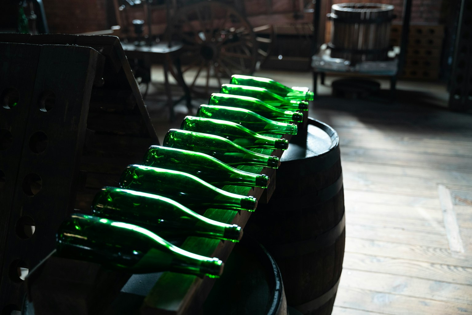 Image of green bottles arranged inside a distillery