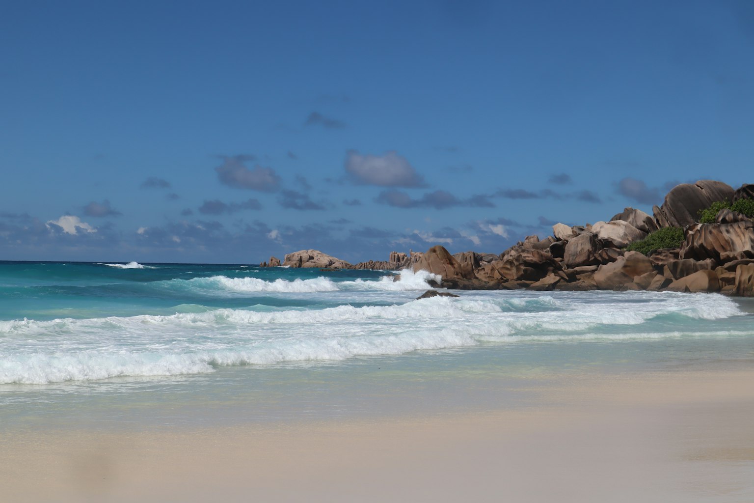 Vista de playa escénica con océano azul y arena blanca