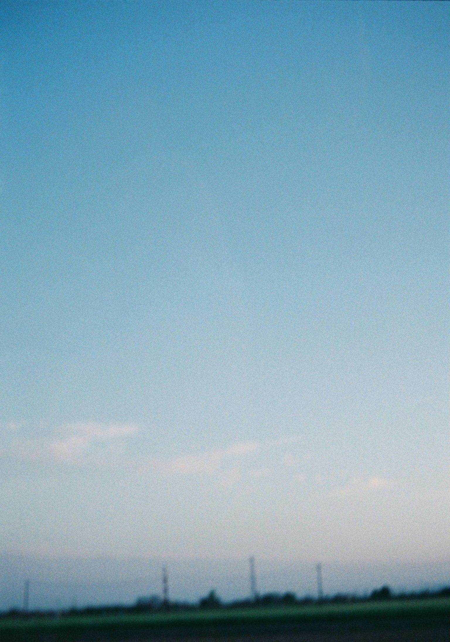 Image of a clear blue sky with soft clouds