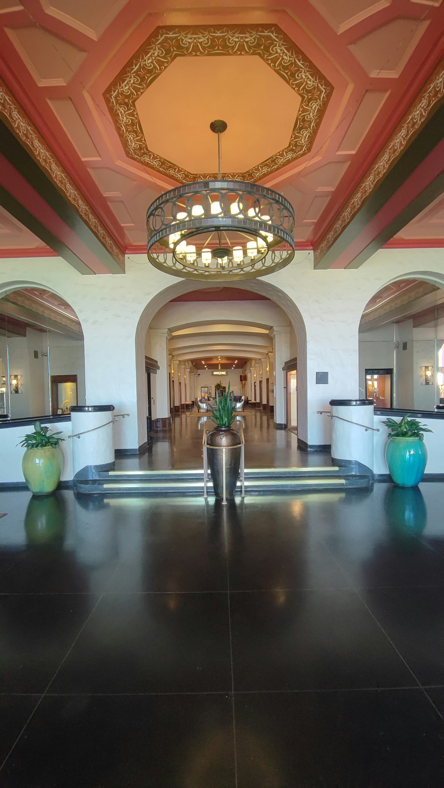 Elegant lobby featuring ornate ceiling and chandelier
