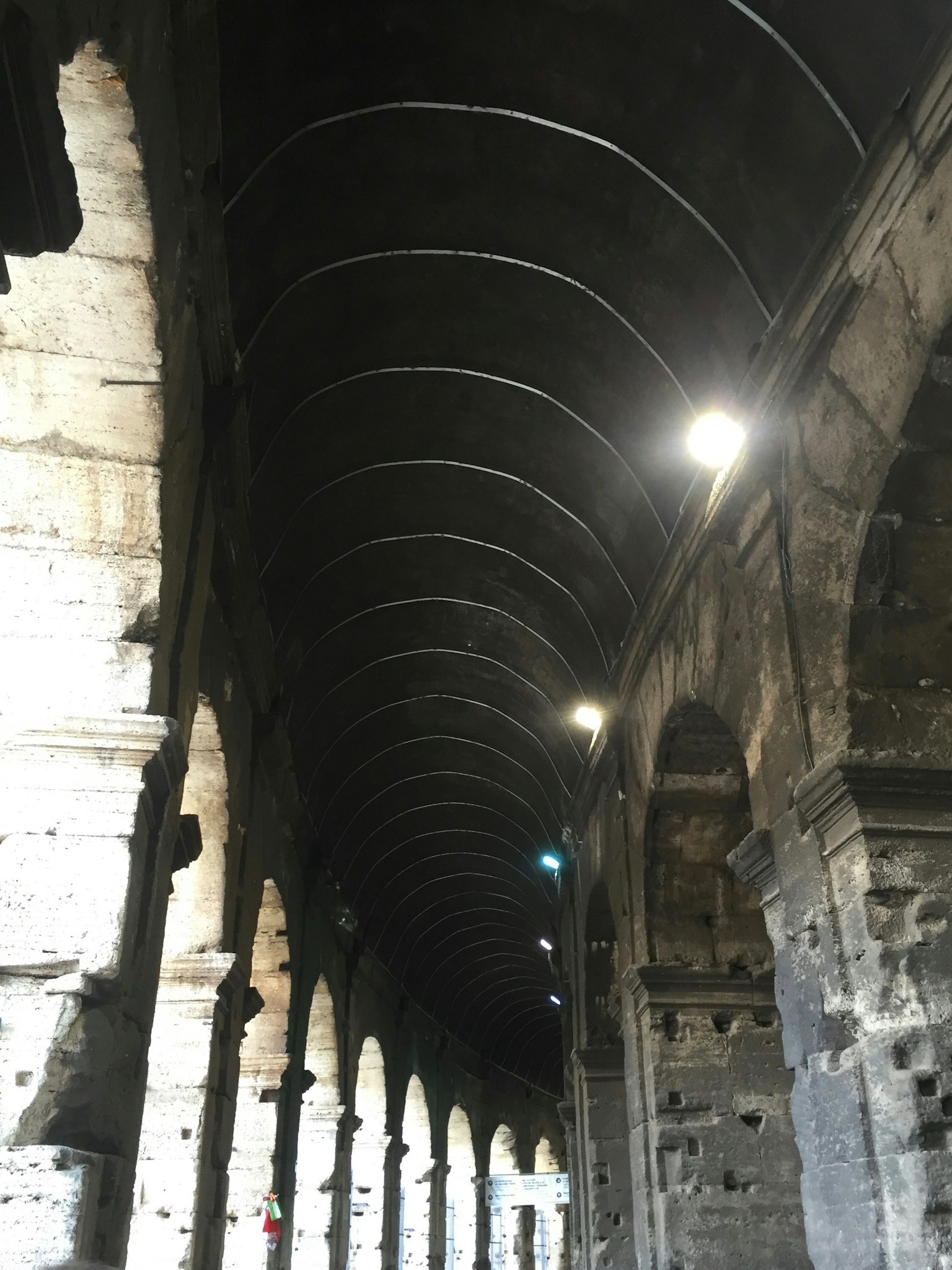 Vista interna di un'antica arcade in pietra con soffitto a volta