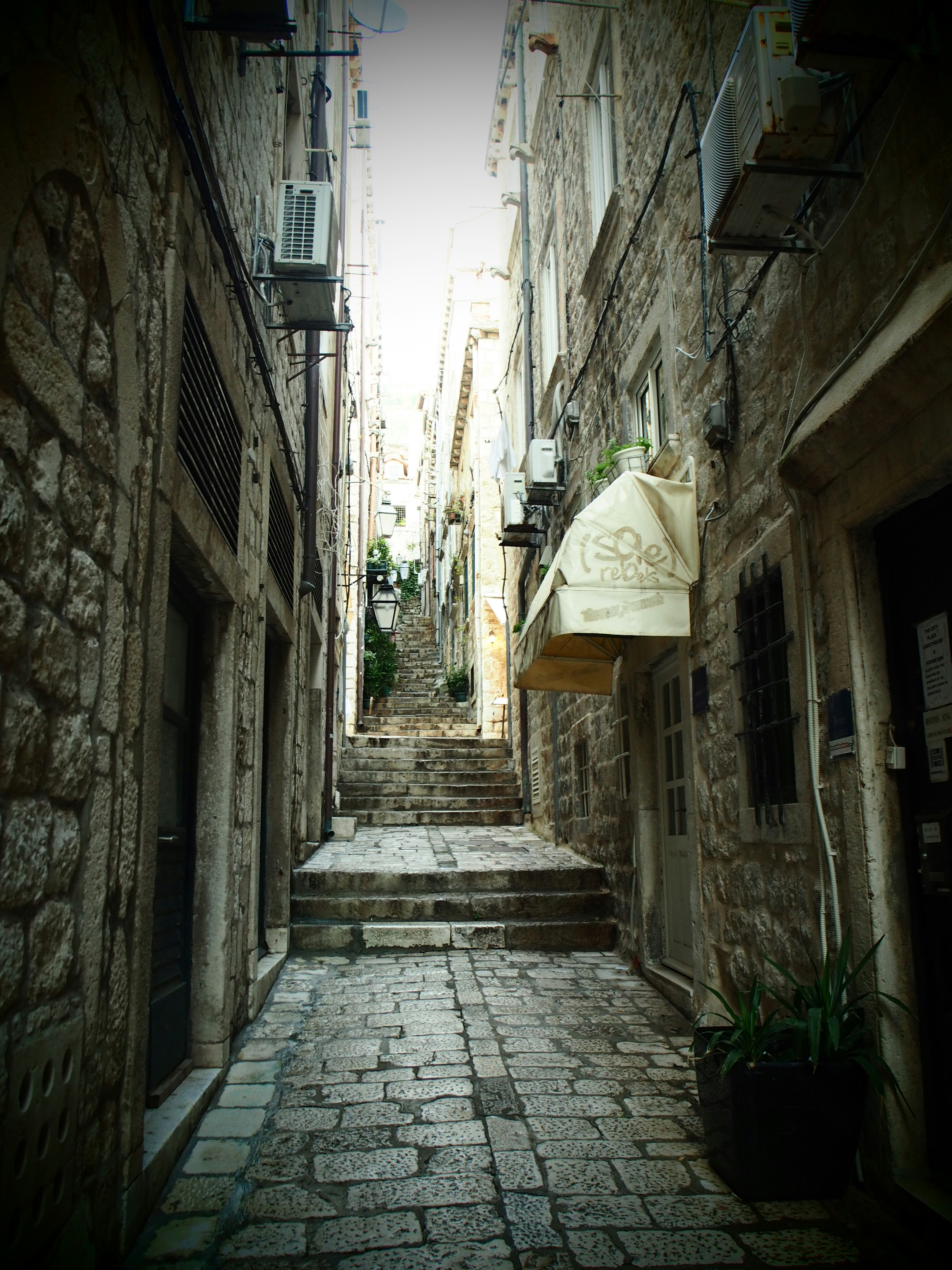 cobblestone alley with stairs in an old town