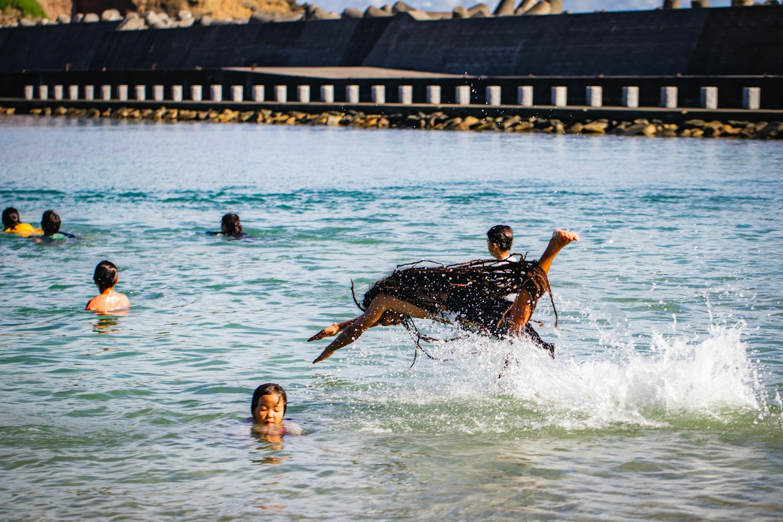 Image of people enjoying the water with a jumping dog