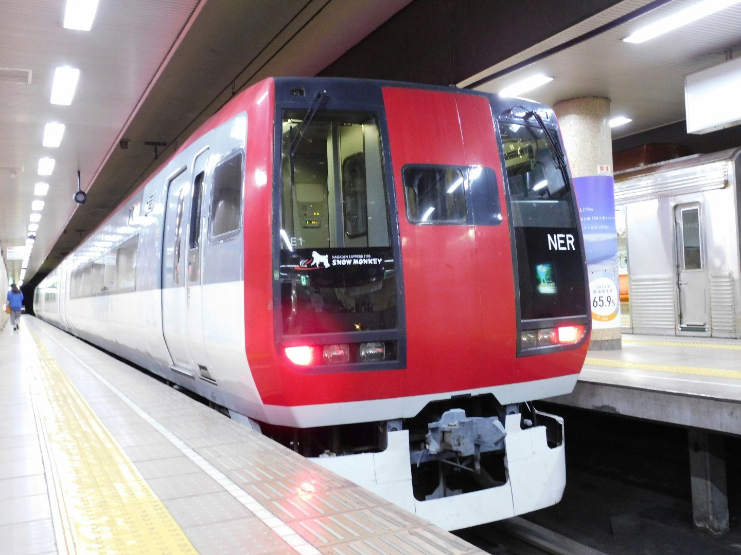 red train stopped at a station platform