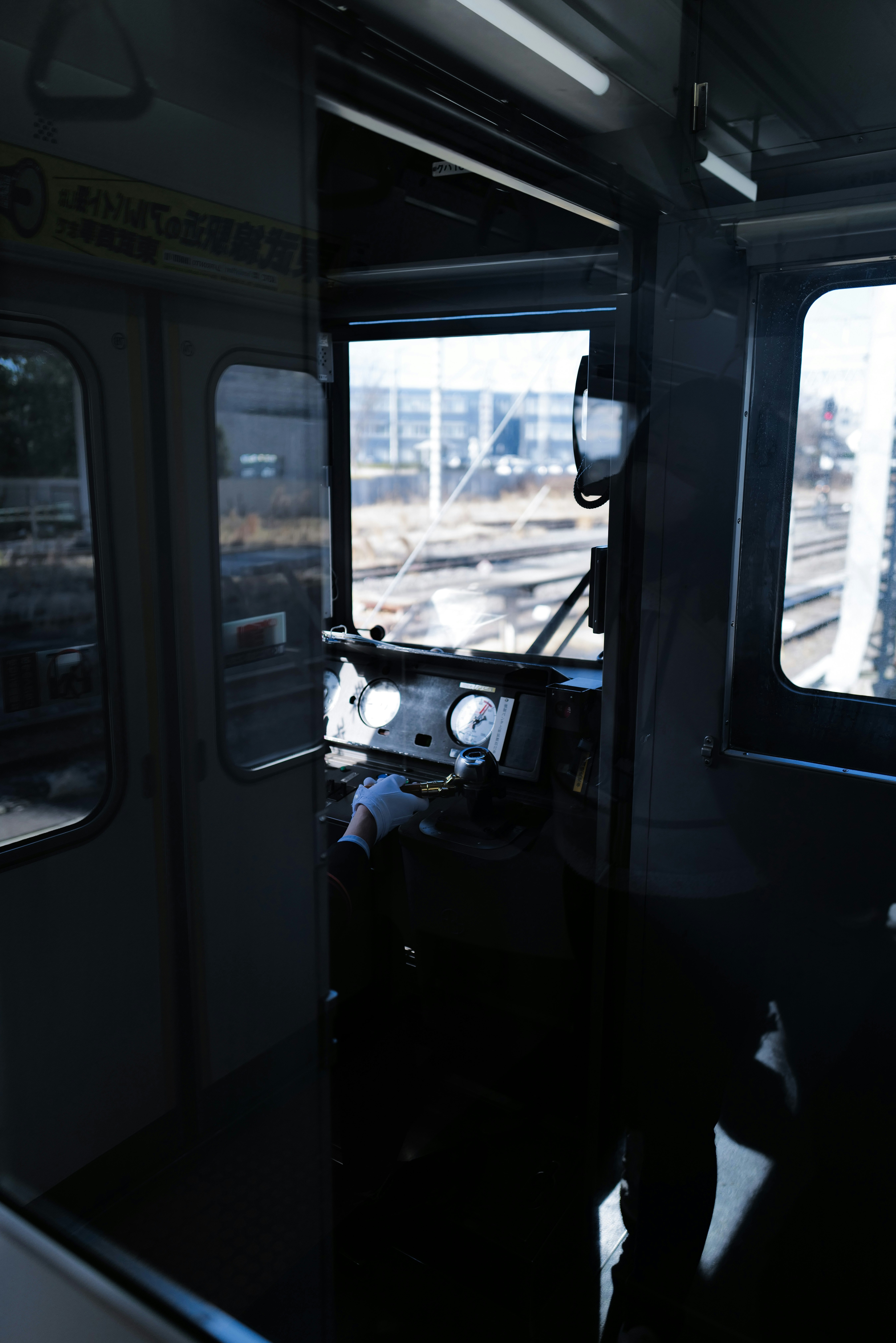 View of tracks and cityscape from inside a train
