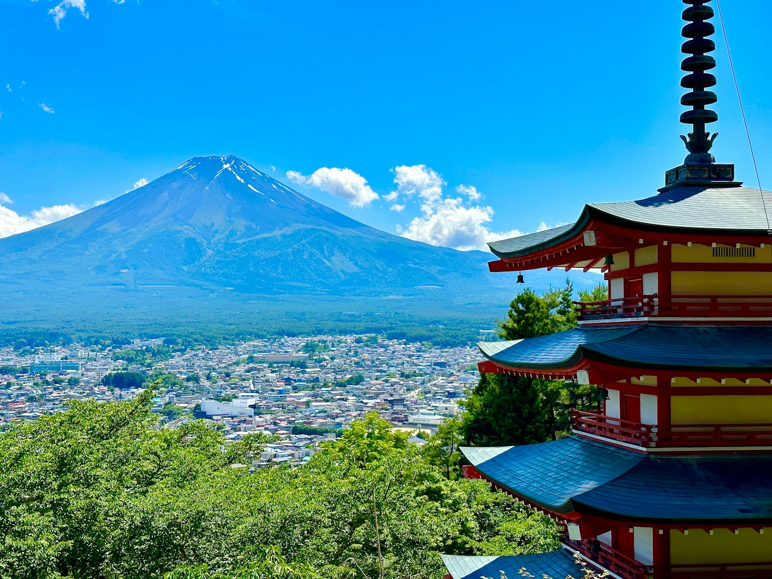 Scenic view of Mount Fuji with a pagoda vibrant blue sky and white clouds