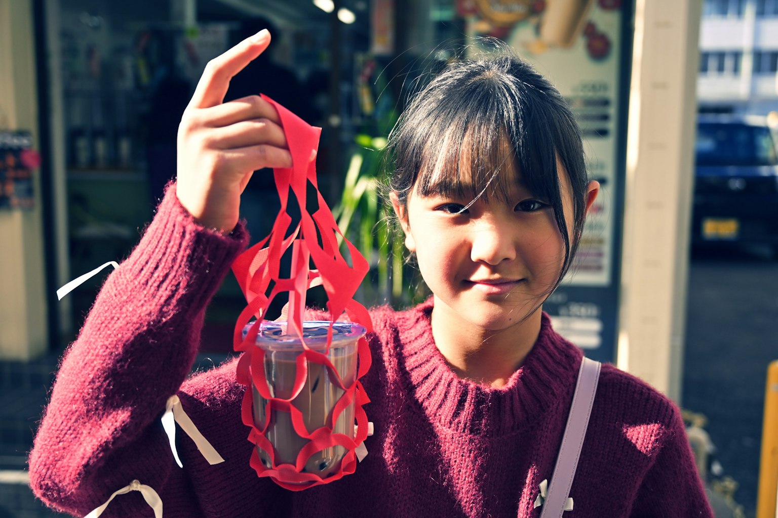 Girl smiling while holding a red basket