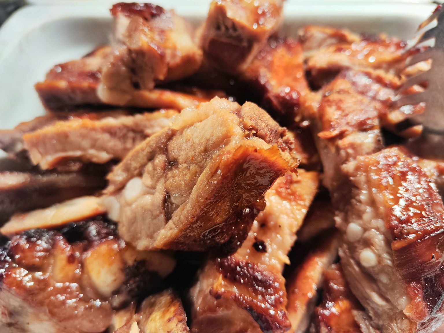 Plate of sliced grilled pork with crispy edges
