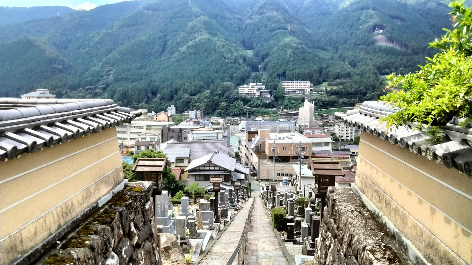 View of a cemetery with a city surrounded by mountains