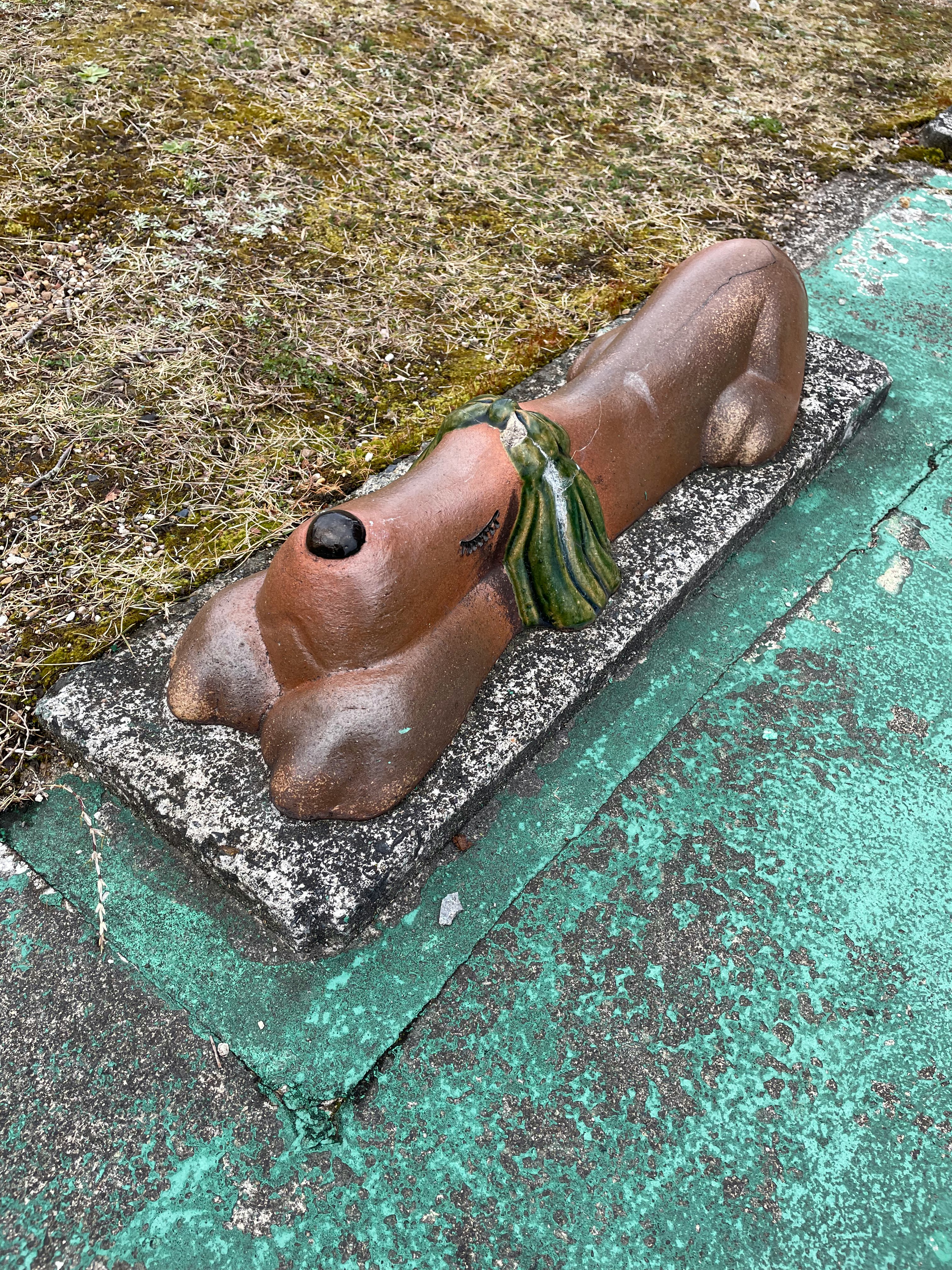 animal sculpture lying beside a grassy edge