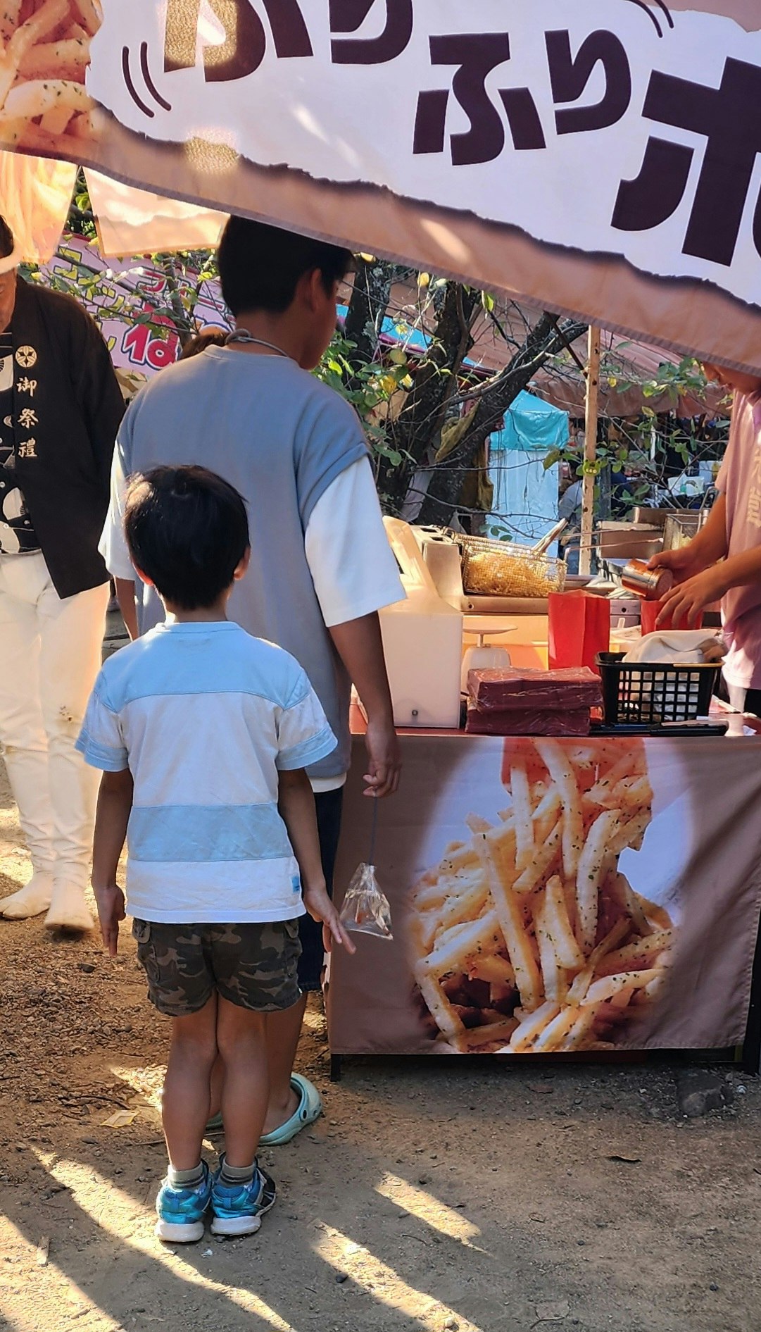 戶外祭典攤位前背影的親子