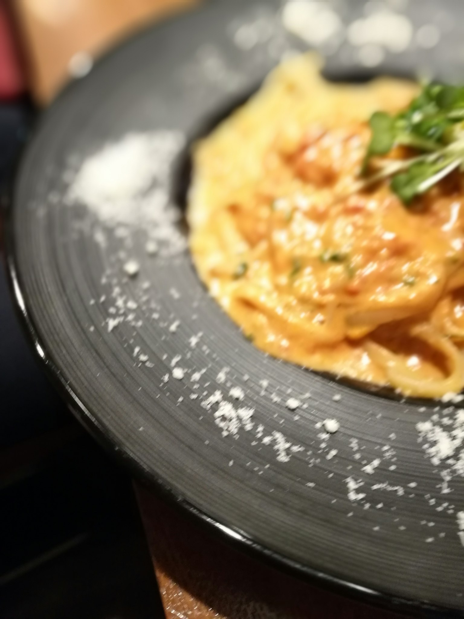 Creamy pasta dish topped with parsley and sprinkled with grated cheese